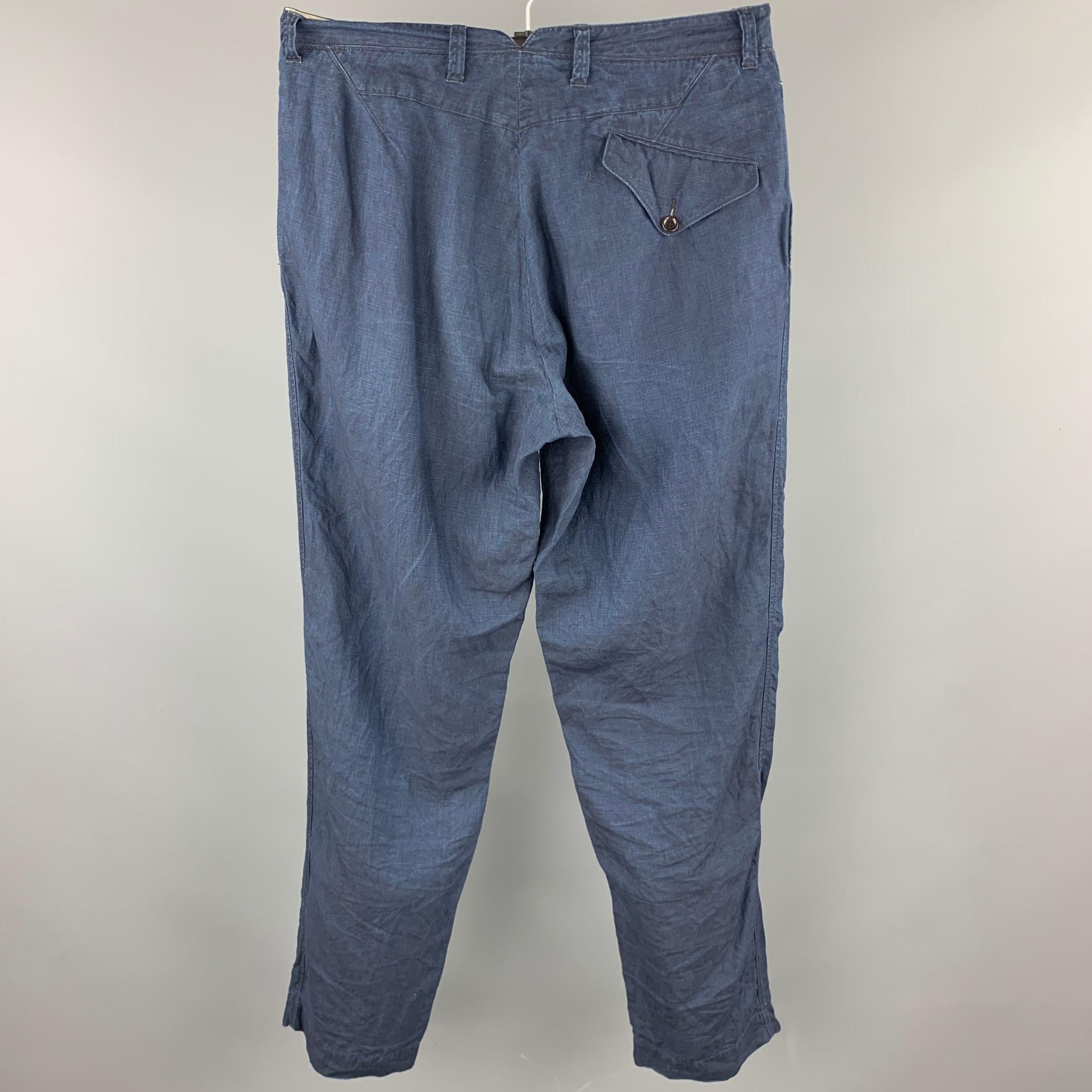 45RPM casual pants comes in a navy linen featuring a drop-crotch style, back pockets, and a zip fly closure. Made in Japan.

Very Good Pre-Owned Condition.
Marked: 34

Measurements:

Waist: 34 in. 
Rise: 11 in. 
Inseam: 34 in. 