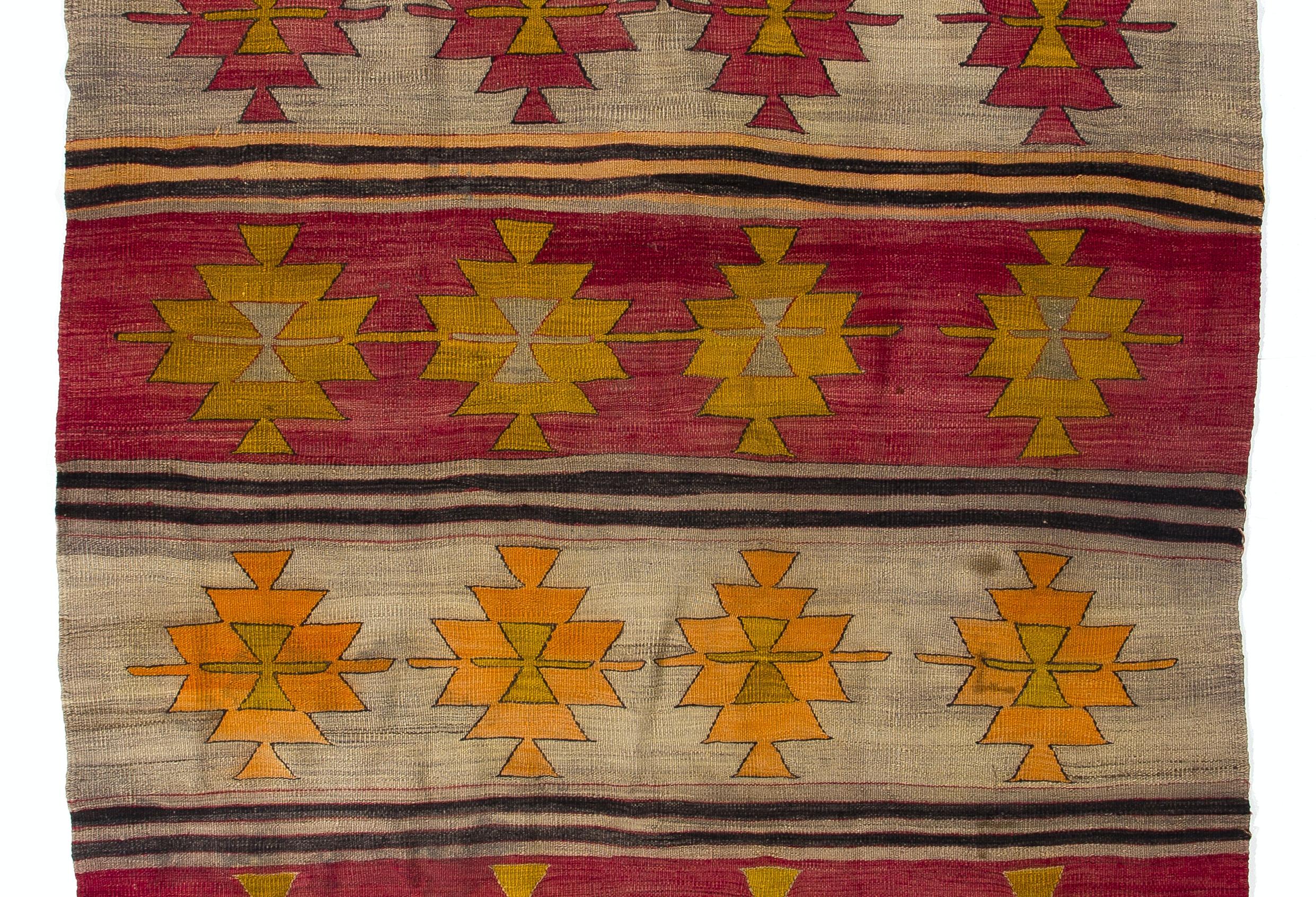 This authentic handwoven flat-weave (Kilim) from Central Turkey was made by Nomads to be used as a floor covering in their tents or summer houses around mid 20th century. It is made of multi colored wool. Measures: 4.5 x 11.6 ft.

These vintage
