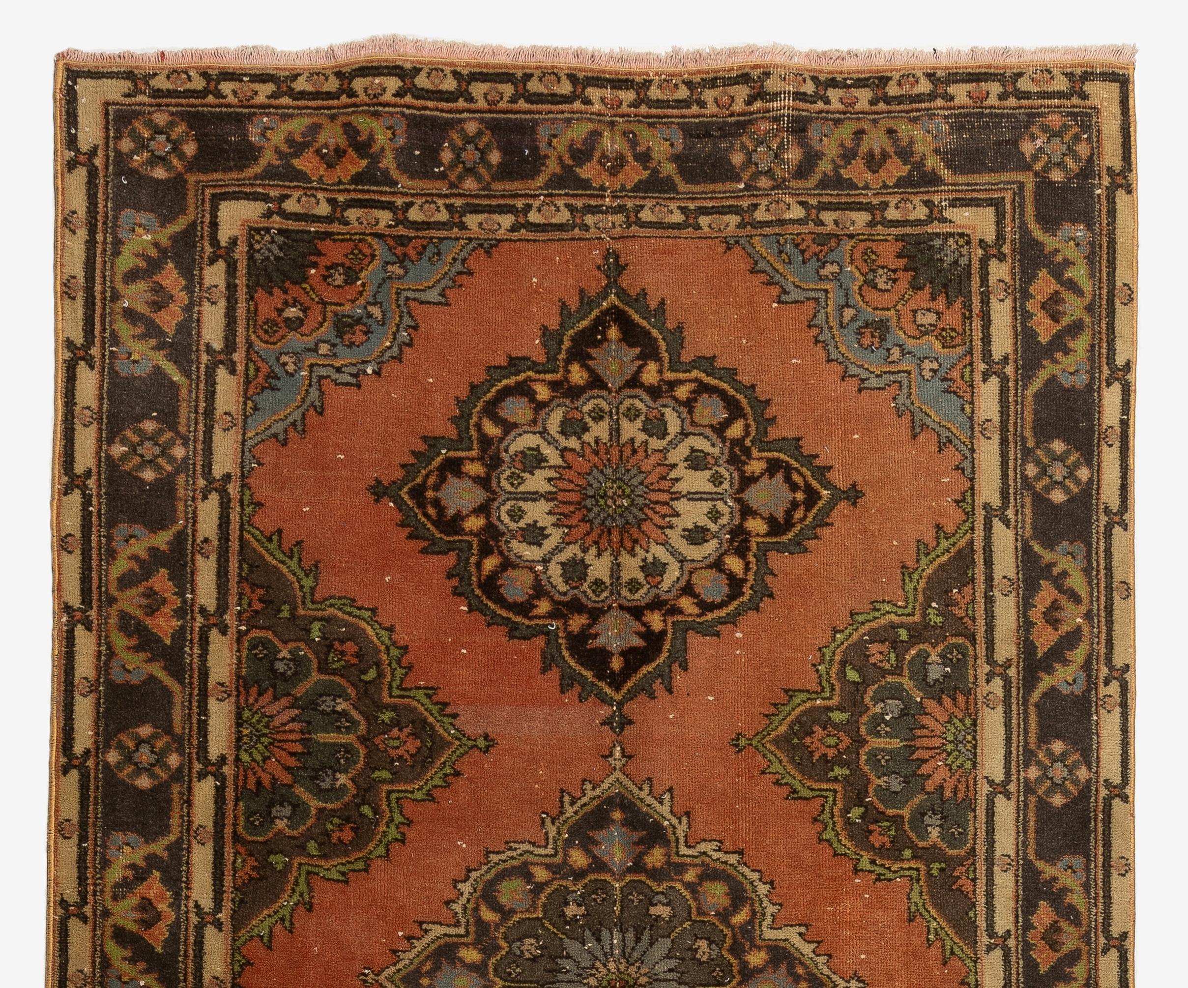 A vintage Turkish runner rug in red, brown and beige. It was hand-knotted in the 1960s with low wool on cotton foundation and features a multiple medallion design. It is in very good condition, professionally-washed, sturdy and suitable for areas
