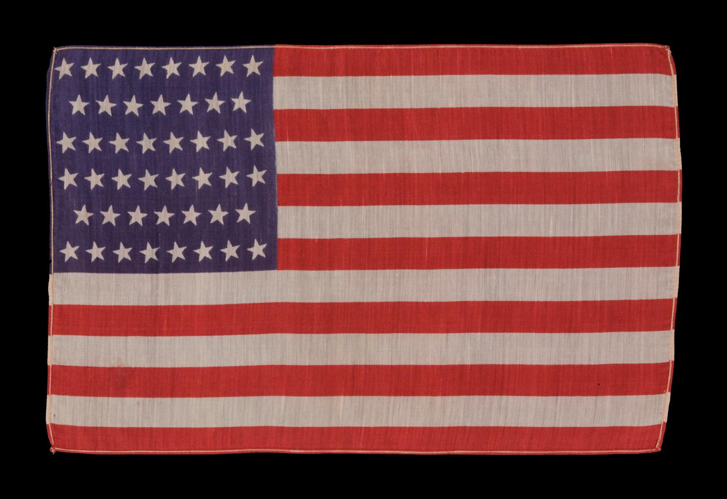 46 stars in canted rows on an antique American parade flag made of silk, 1907-1912, Oklahoma Statehood:

46 star American parade flag, printed on silk. Oklahoma joined the Union as the 46th state on November 16th, 1907, during Teddy Roosevelt’s