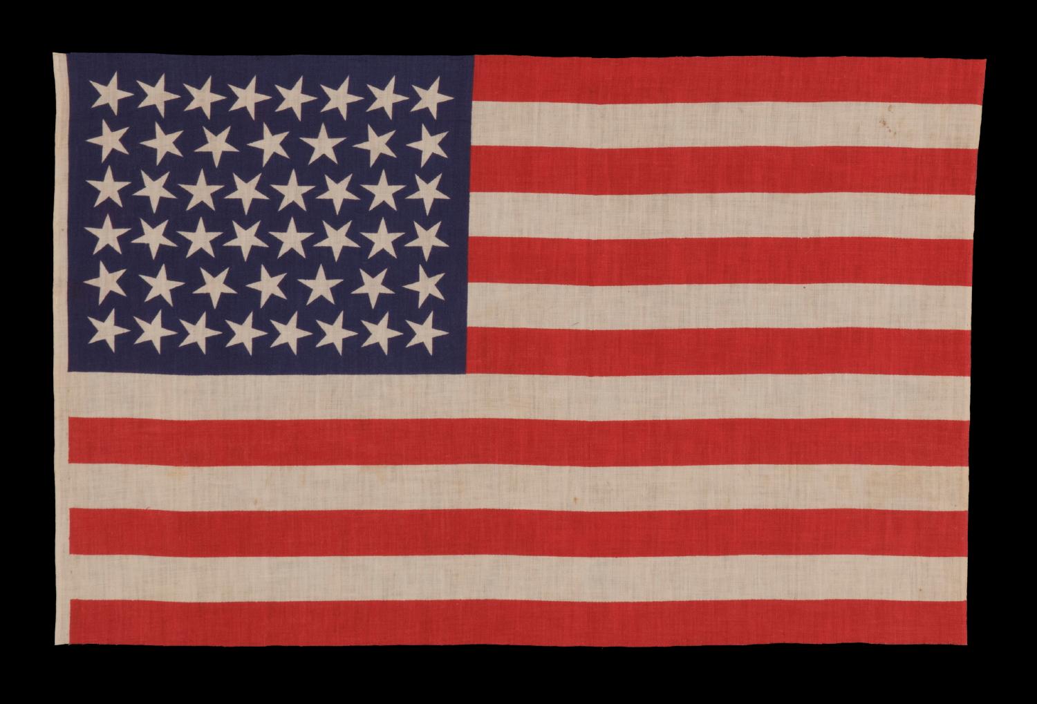 46 stars with varied star positioning on an antique American flag, 1907-1912, reflects Oklahoma statehood:

46 star American national parade flag, printed on plain weave cotton. The stars of the flag are configured in staggered rows of