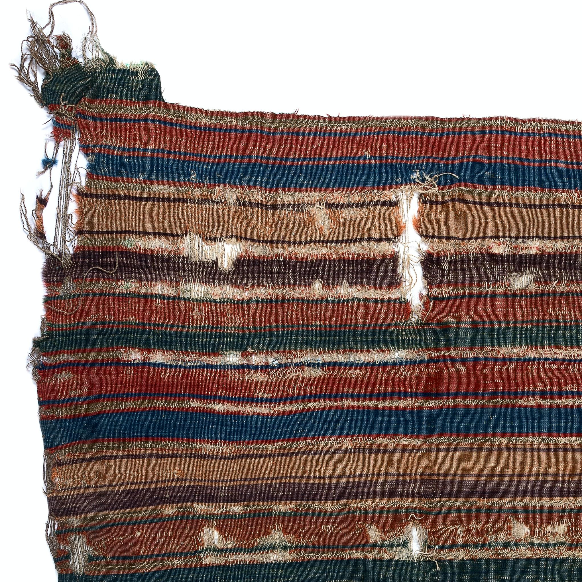Embark on a journey through time and tradition with this exquisite Antique Anatolian fragment distressed kilim, a rare artifact dating back to the 18th century. Crafted with meticulous skill and artistry by Anatolian weavers over three centuries