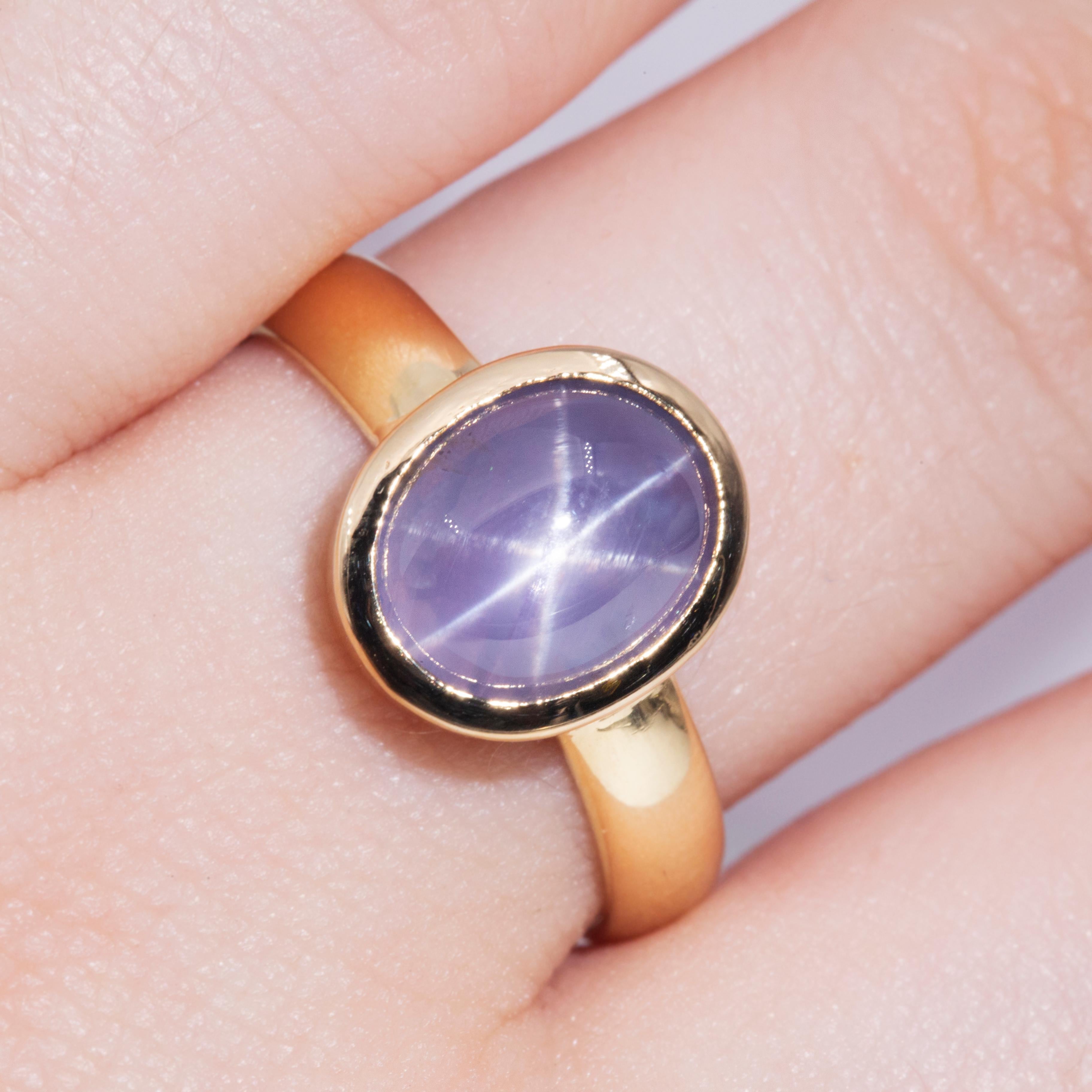 Forged in 18 carat yellow gold, this opulent solitaire vintage ring features an enchanting and rare 4.60 carat Ceylon blue cabochon star sapphire in a darling rubover setting. The captivating translucent blue and the 6-ray star make this jewel a