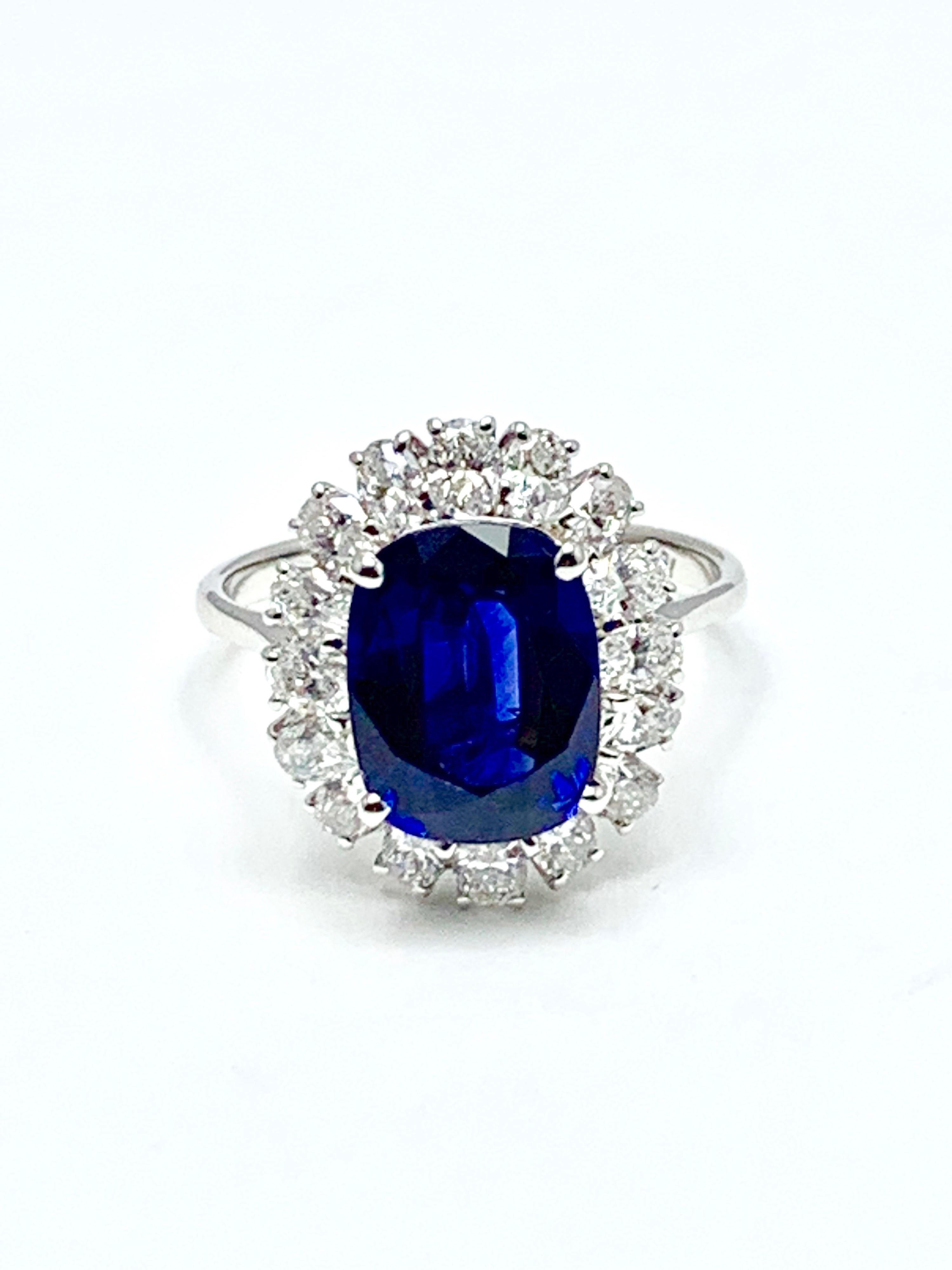 A stunning 4.60 carat cushion mixed cut Sapphire and diamond cocktail ring set in 18 karat white gold.  The Sapphire is prong set with 16 oval brilliant Diamonds surrounding, consisting of 1.28 carats total weight.  The Sapphire has bee graded by