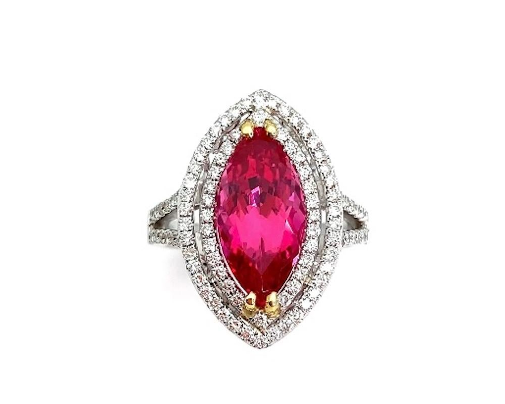 This stunning cocktail ring features a 4.60 carat, gem-quality, hot pink spinel set in an 18k gold and white diamond halo ring. The spinel is a spectacular fuchsia color with extraordinary clarity and brilliance that is accented by the 18k yellow