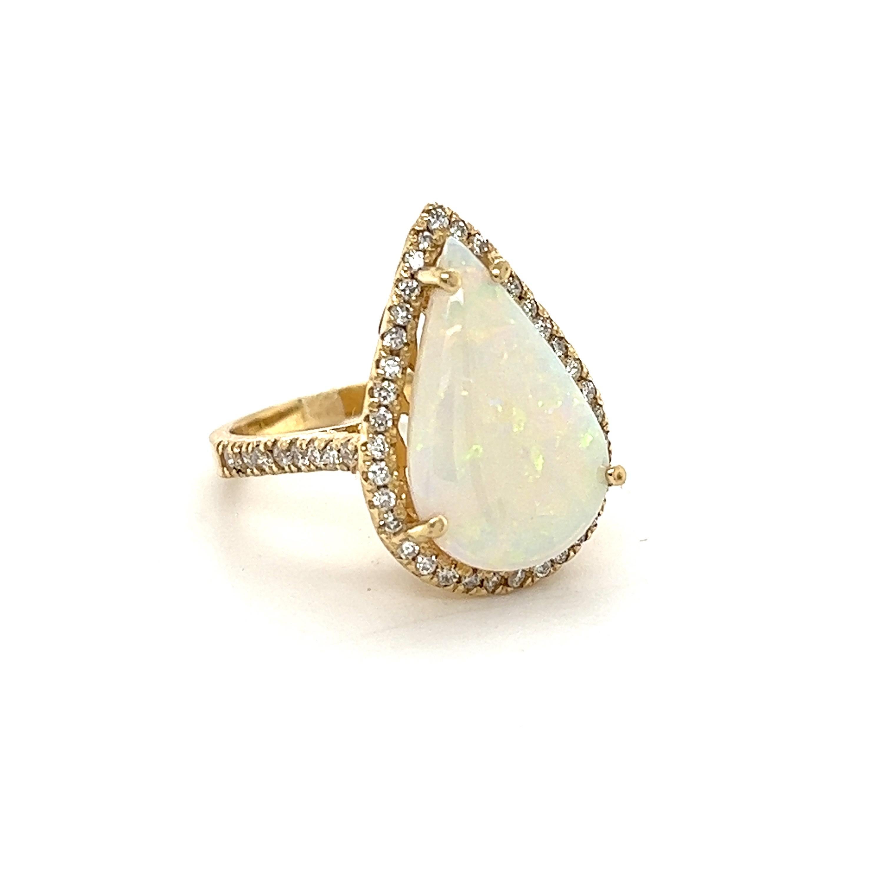 Pear Cut Opal measures at 18 mm x 12 mm and is 4.03 carats. It is surrounded by 53 Round Cut Diamonds that weigh 0.57 Carats. (Clarity: SI, Color: F) The total carat weight is 4.60 carats. 

The ring is made in 14K Yellow Gold and weighs