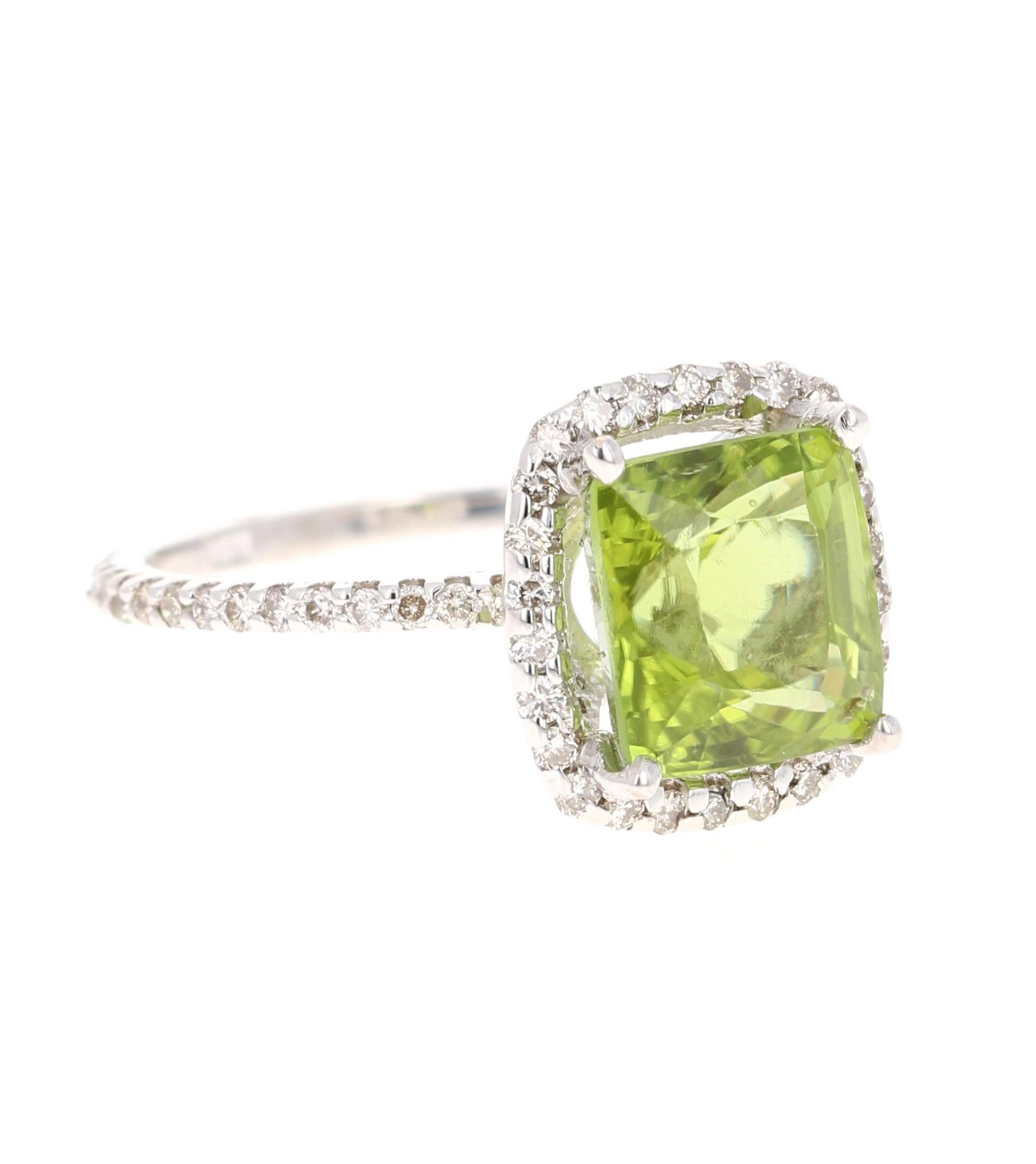 Peridot Diamond White Gold Engagement Ring
Bright, Beautiful and Bling! 

This ring has a 4.08 Carat Square-Cushion Cut Peridot and has 56 Round Cut Diamonds that weigh 0.52 Carats. The total carat weight of the ring is 4.60 Carats. 

It is set in