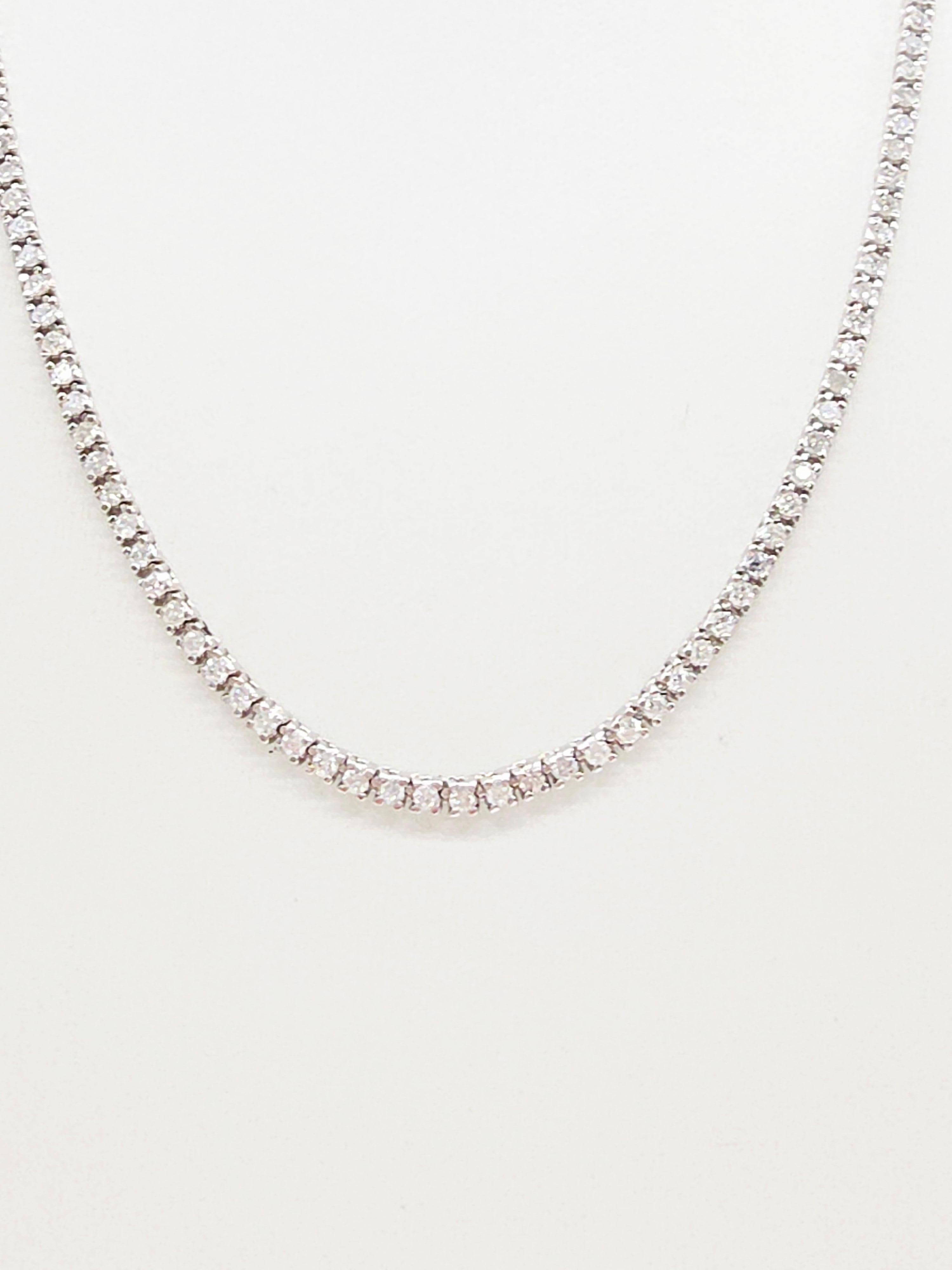 A luxurious and brilliant tennis necklace showcasing 4.60 carats of natural round-brilliant cut white diamonds. Set in solid 14k white gold with a classic four-prong style that maximizes sparkle and light reflection.

Carat Weight: 4.60 cts

Gold: