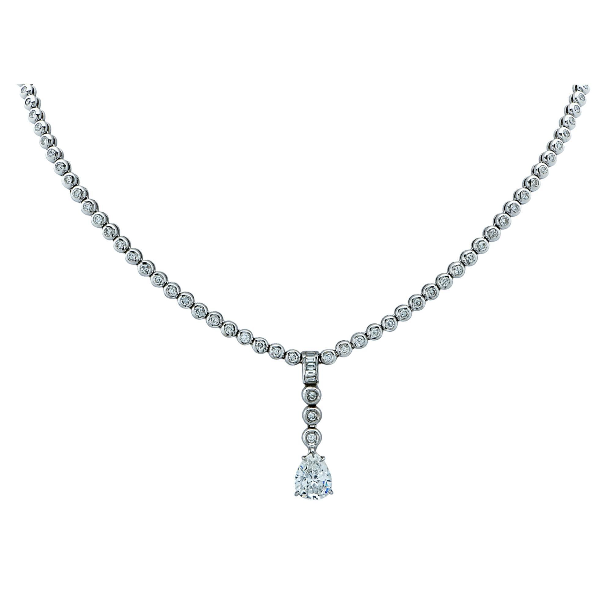 A spectacular 18k white gold diamond necklace featuring a gorgeous pear brilliant cut diamond weighing approximately 2.10cts G color SI clarity gracefully cascading from a stunning diamond necklace featuring 68 round brilliant and baguette cut