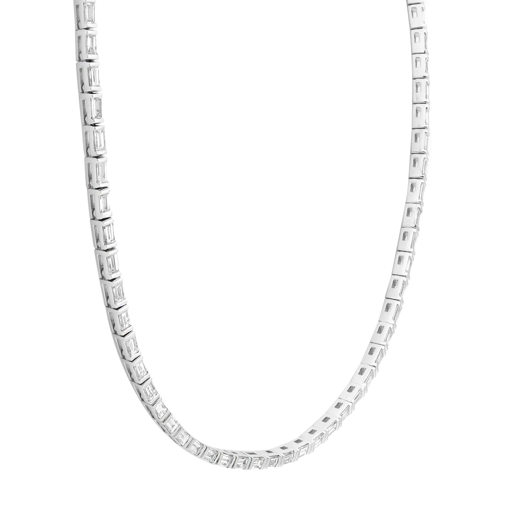 This dazzling diamond tennis necklace is perfect for a shimmering evening look. Crafted in fine 18k white gold. This sparkling Baguette cut diamond lined tennis necklace features 107 diamonds totaling 4.60 carats in half bezel setting. Diamond