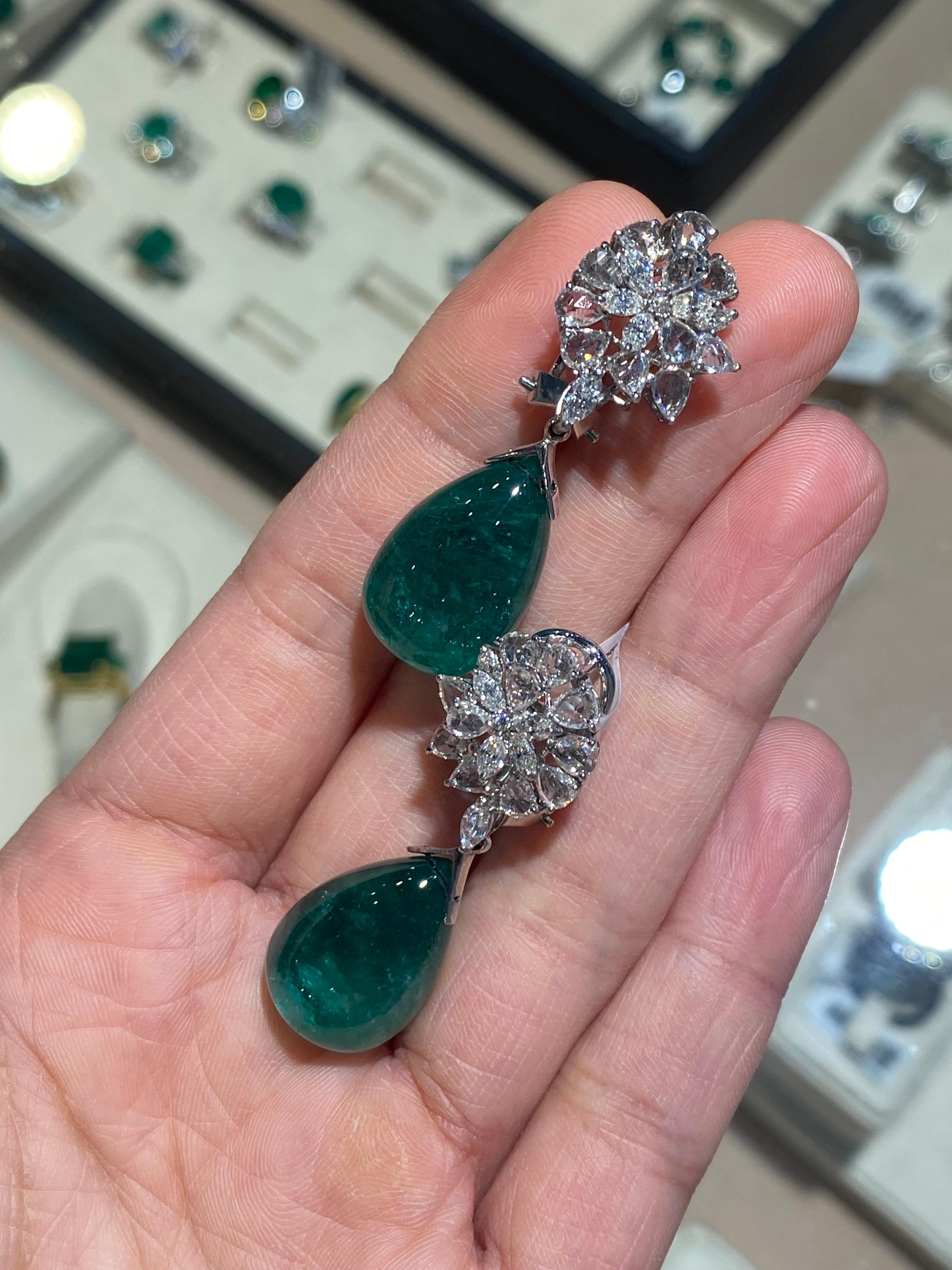 A beautiful pair of 46.1 carat natural Emerald drops earring with full cut and rose cut White Diamonds, set in 18K Gold.