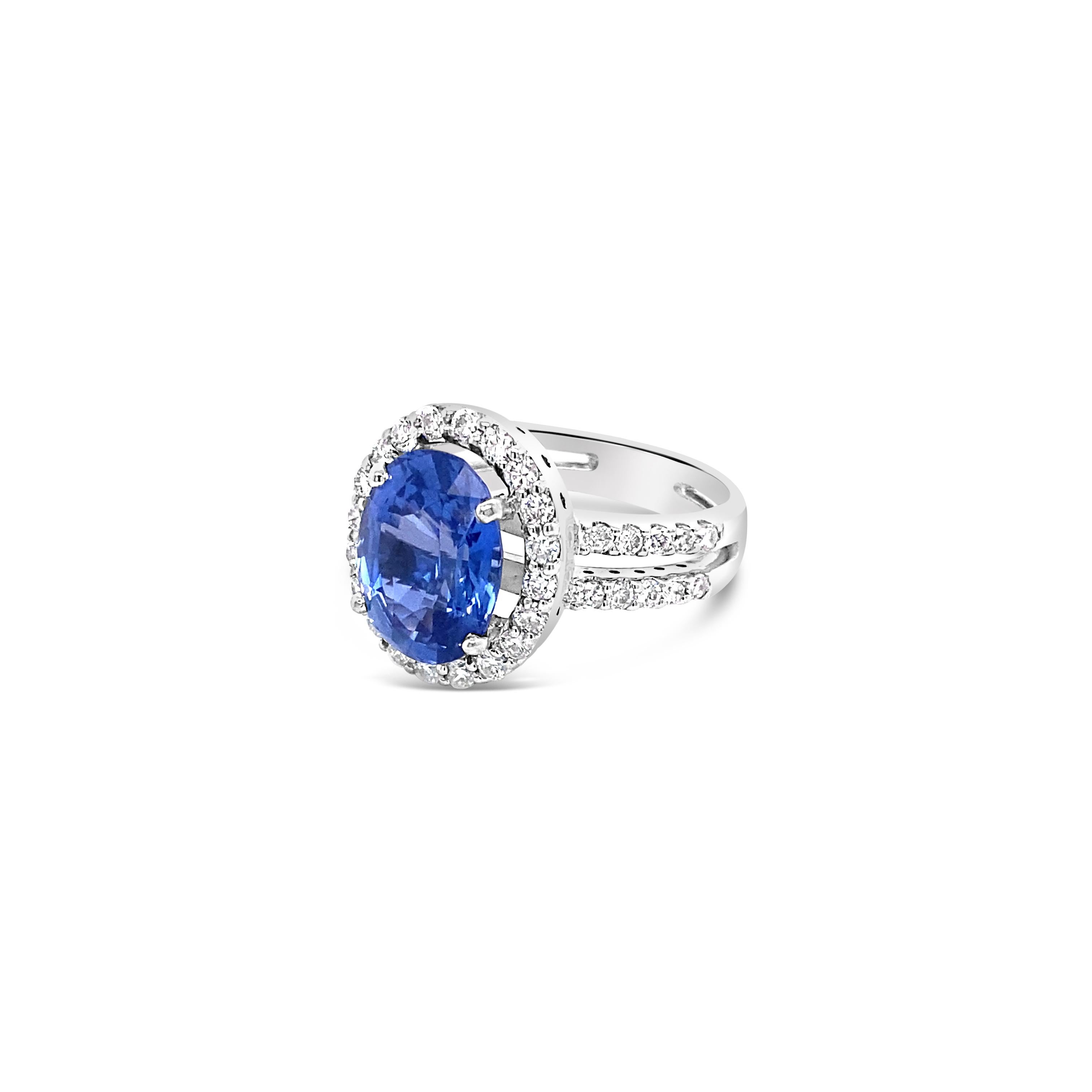 This ring features a stunning 4.61 carat oval cut natural Burma sapphire with no heat. The ring is set in 18 karat white gold accented by 0.73 carat total weight in round diamonds in a halo and along the double shank. This is a very rare sapphire