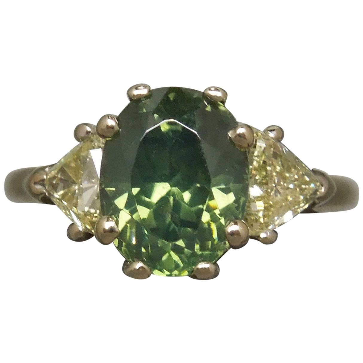 4.61 Carat Oval Green GIA Zircon and Trillion Cut Diamond Three-Stone Ring For Sale