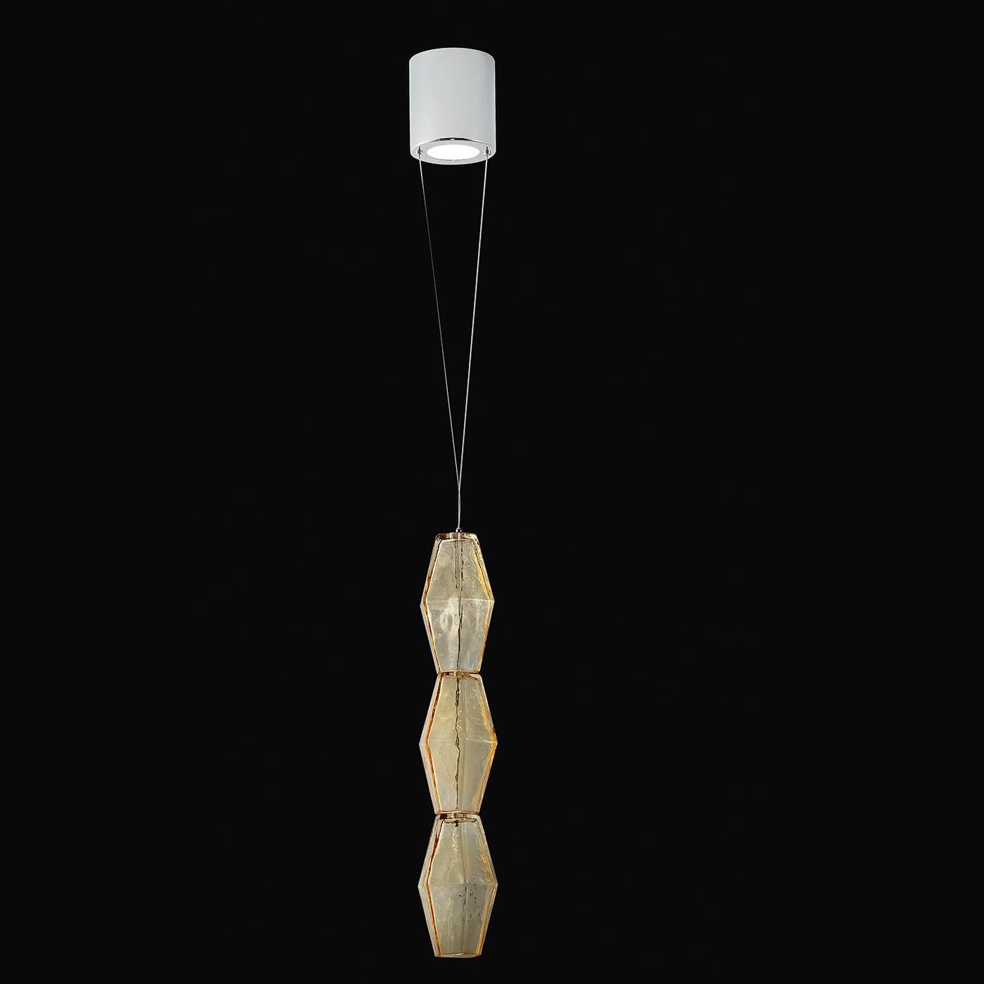 In a simple and artistic design, this suspension lamp features a hand blown colored glass pendant in three geometric shaped sections. The lamp is housed in the canopy with a polished chrome or 24-karat gold finish and this highly original suspension