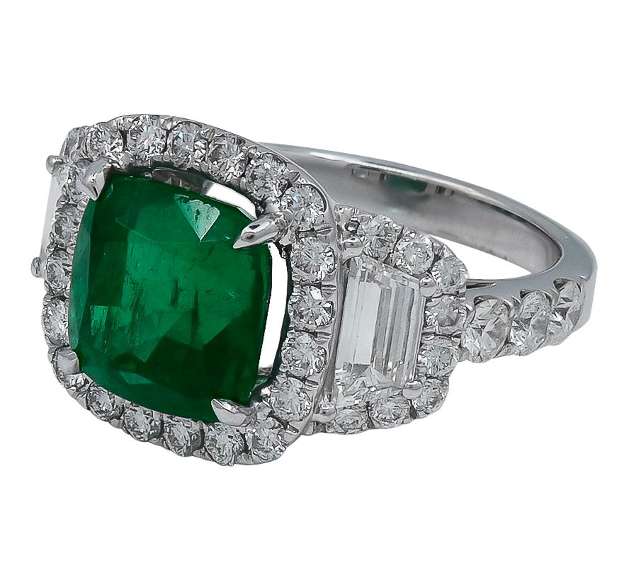 An Exceptional 4.62 carat African Emerald and Diamond Ring. This ring centers  a cushion cut 4.62 ct. African Emerald, surrounded by white round diamonds weighing 1.62 carats and  2 white trapezoids weighing .62 carats. 