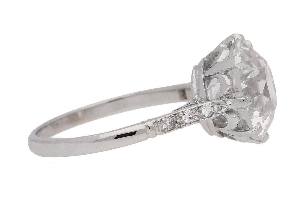 Solitaire old cut diamond ring with diamond set shoulders. Set centrally with a round old cut diamond, H colour, VS1 clarity, with a weight of 4.62 carats in an open back claw setting, further set with six round single cut diamonds in open back