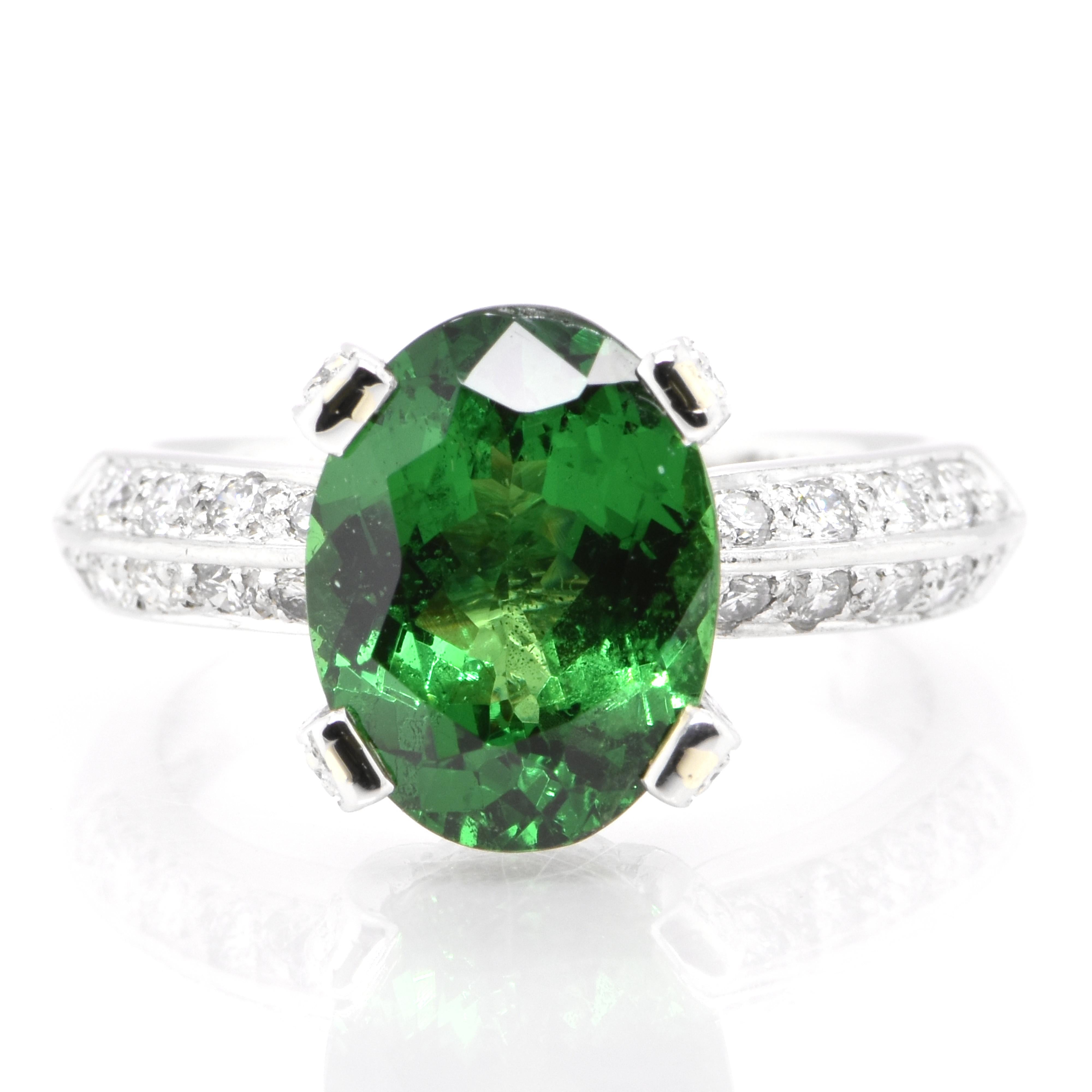 An absolutely gorgeous cocktail ring featuring a 4.62 Carat Tsavorite Garnet and 0.70 Carats of Diamond Accents set in Platinum. Garnets have been adorned by humans throughout history from Ancient Egypt, Rome and Greece. They come in a wide variety