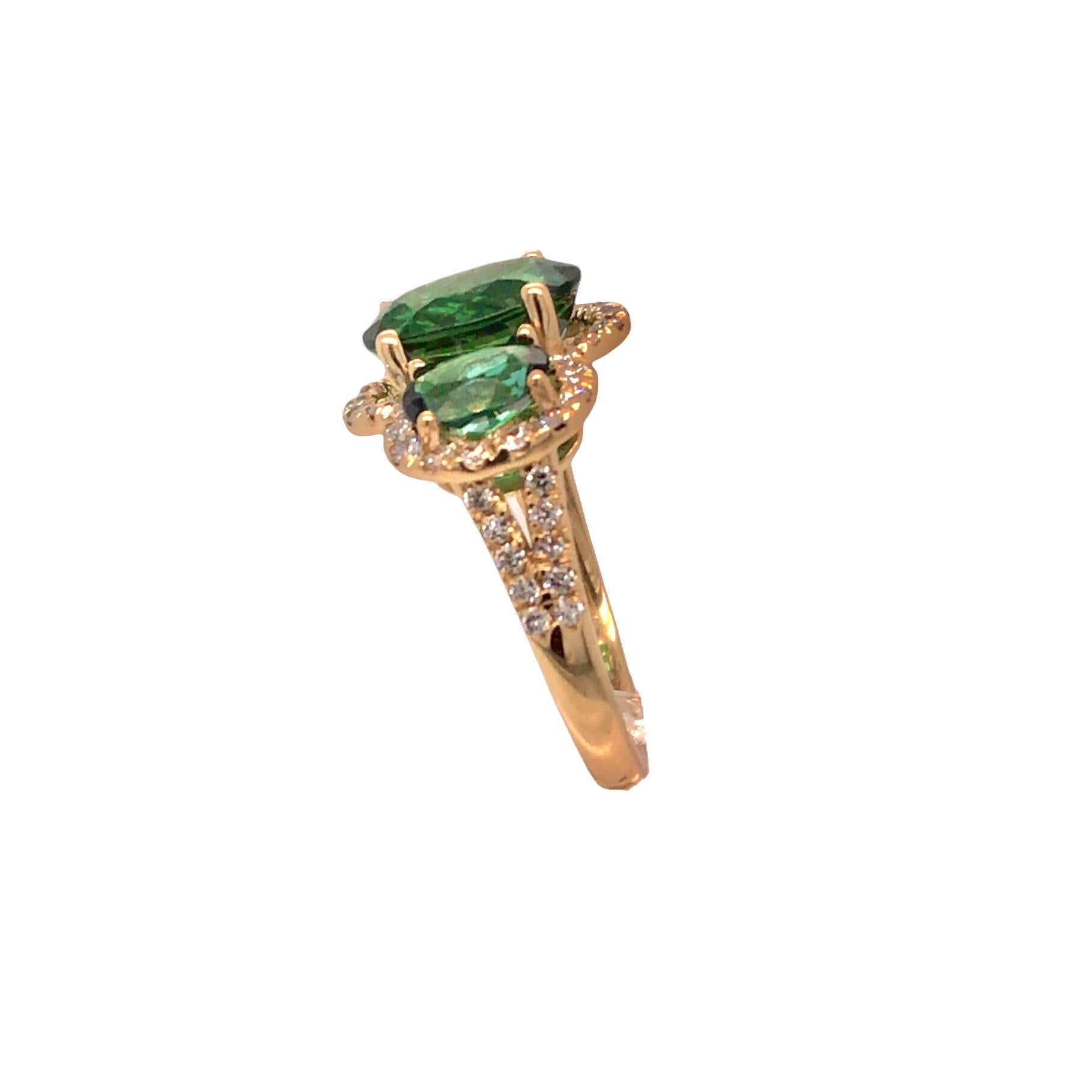 Elevate your style with the epitome of elegance and luxury. Our exquisite ring features three stunning oval-cut green tourmalines, totaling a remarkable 4.62 carats. These vibrant gemstones are framed by a radiant halo of brilliant, natural white