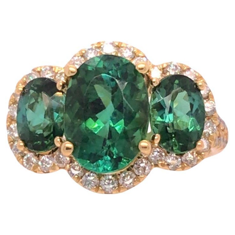 4.62 Carat Oval Cut Green Tourmaline 3-Stone Ring with Diamond Halo in 18 Yellow For Sale