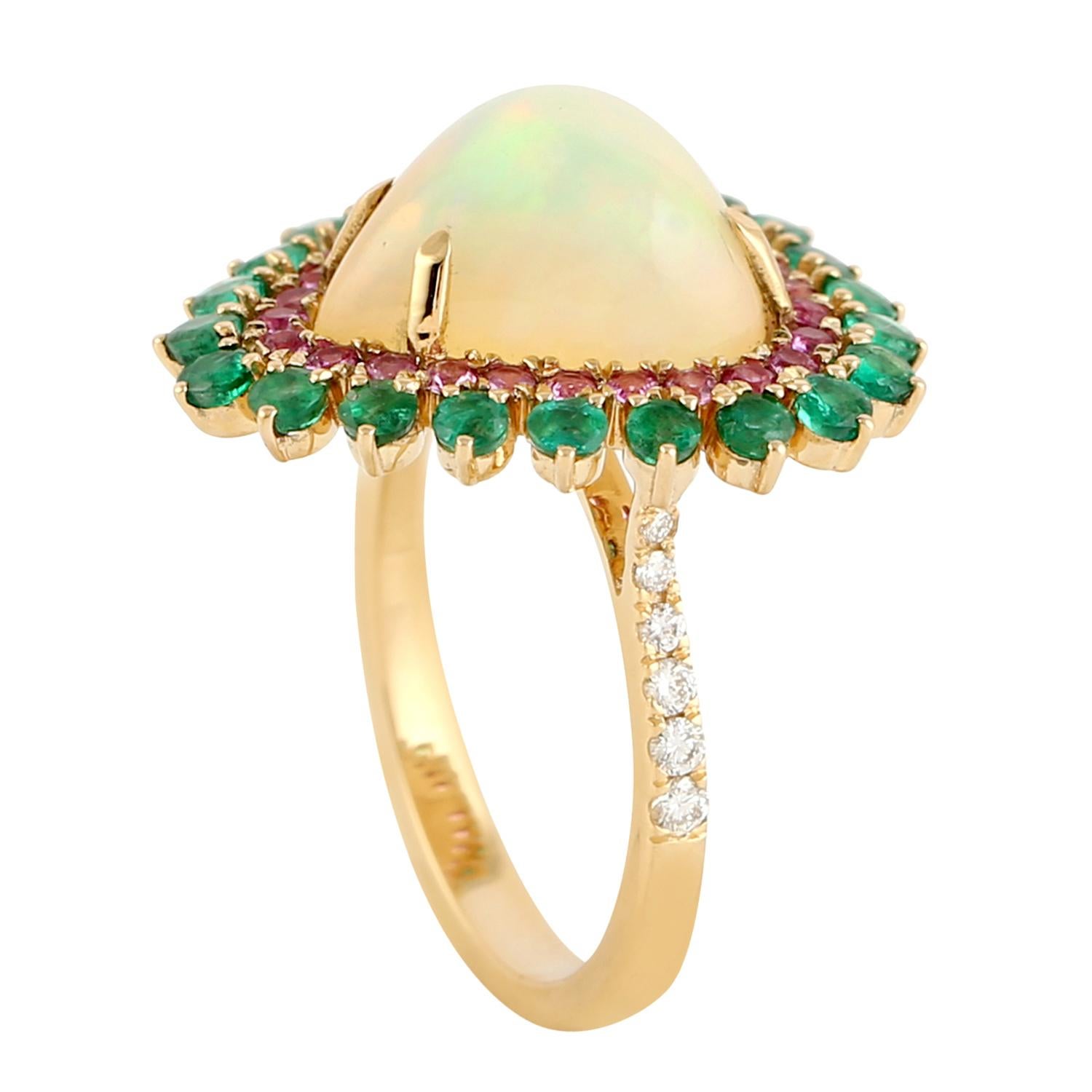 This ring has been meticulously crafted from 18-karat gold.  It is hand set with 4.62 carats opal, 1.09 carats emerald, .6 carats sapphire & .17 carats of sparkling diamonds. 

The ring is a size 7 and may be resized to larger or smaller upon