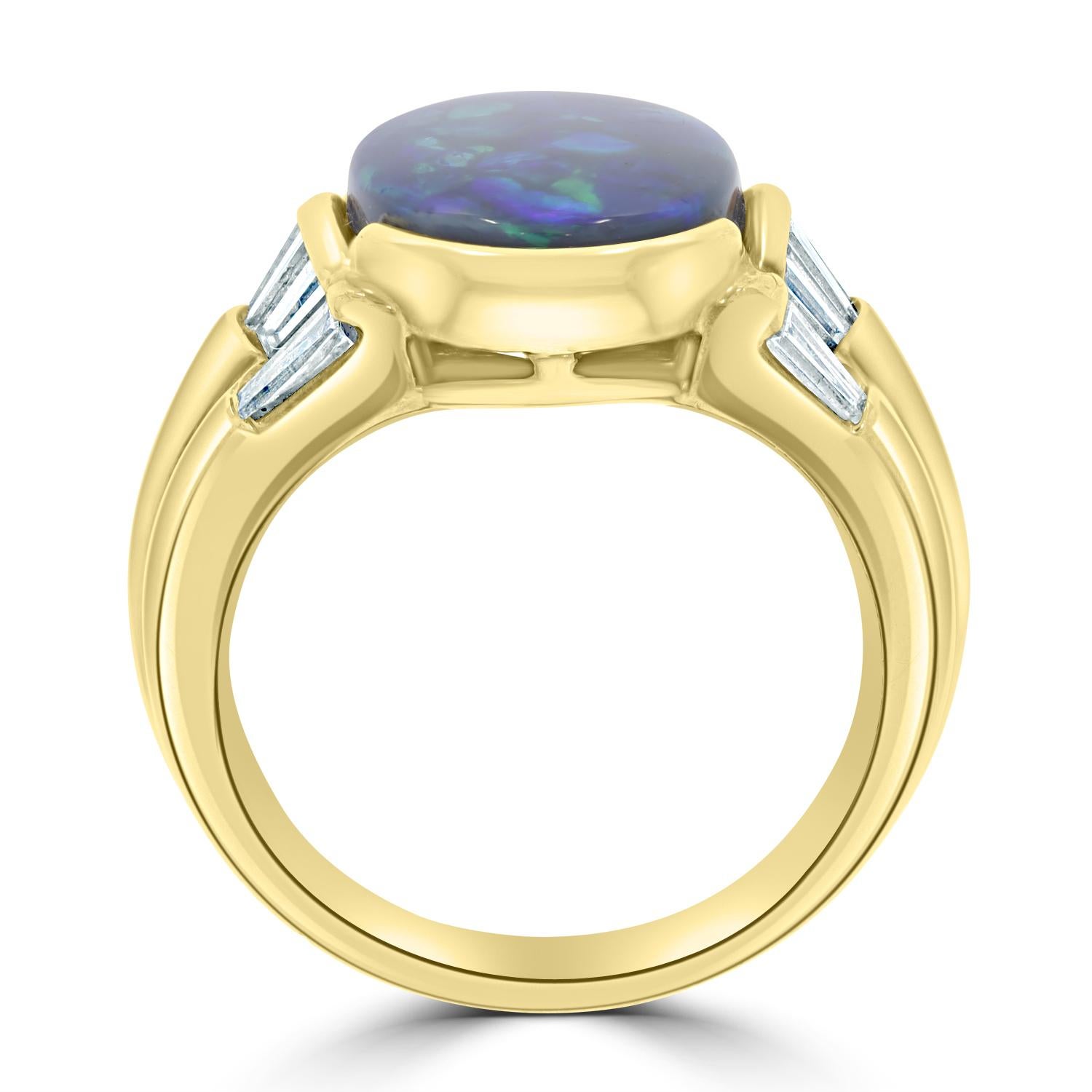 Crafted of 18K yellow gold, this captivating ring is perfect for any occasion. set with an eye-catching oval cut Black Opal at the center, this flattering ring is enhanced by dazzling round cut Diamonds that encircle it.
