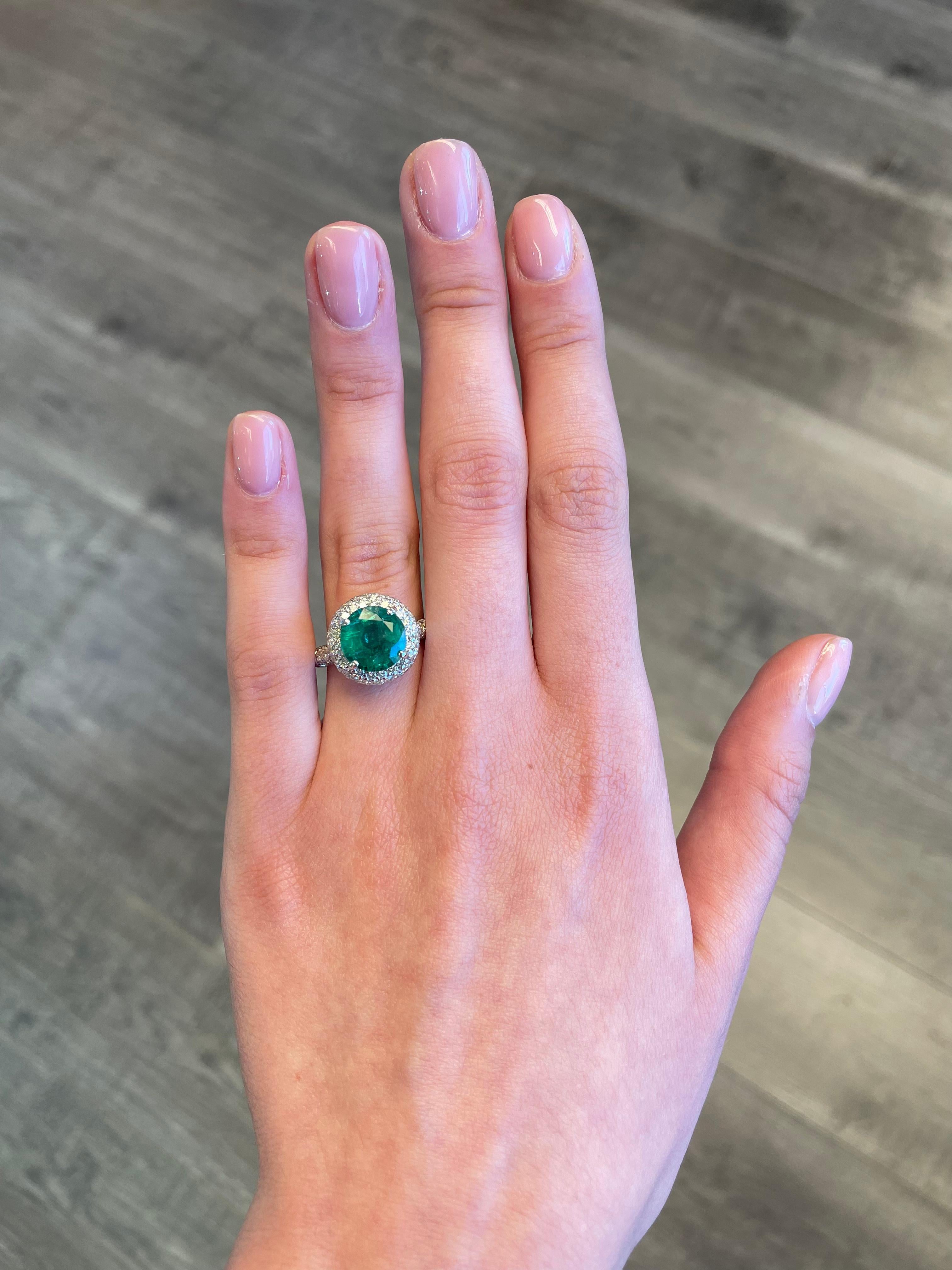 Beautiful emerald with pave diamonds.
4.62 carats total gemstone weight.
3.17 carat round cut emerald. Complimented by 1.45 carats of round diamonds, approximately G/H color and SI clarity. 18k white gold, 7.12 grams, current ring size 7.5.