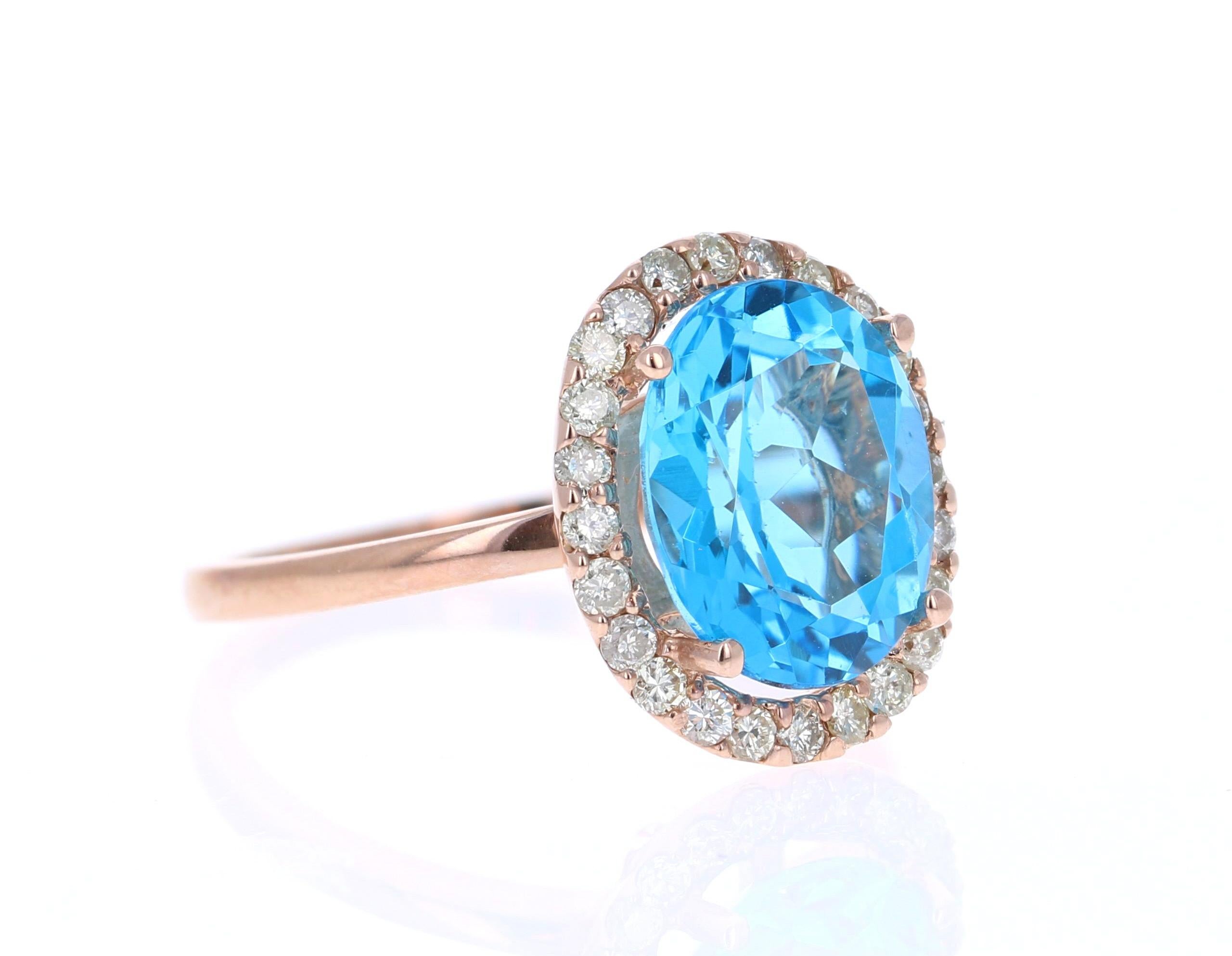 This beautiful Oval cut Blue Topaz and Diamond ring has a striking 4.21 Carat Blue Topaz and its surrounded by 24 Round Cut Diamonds that weigh 0.42 Carats. The total carat weight of the ring is 4.63 Carats. 

The setting is crafted in 14K Rose Gold