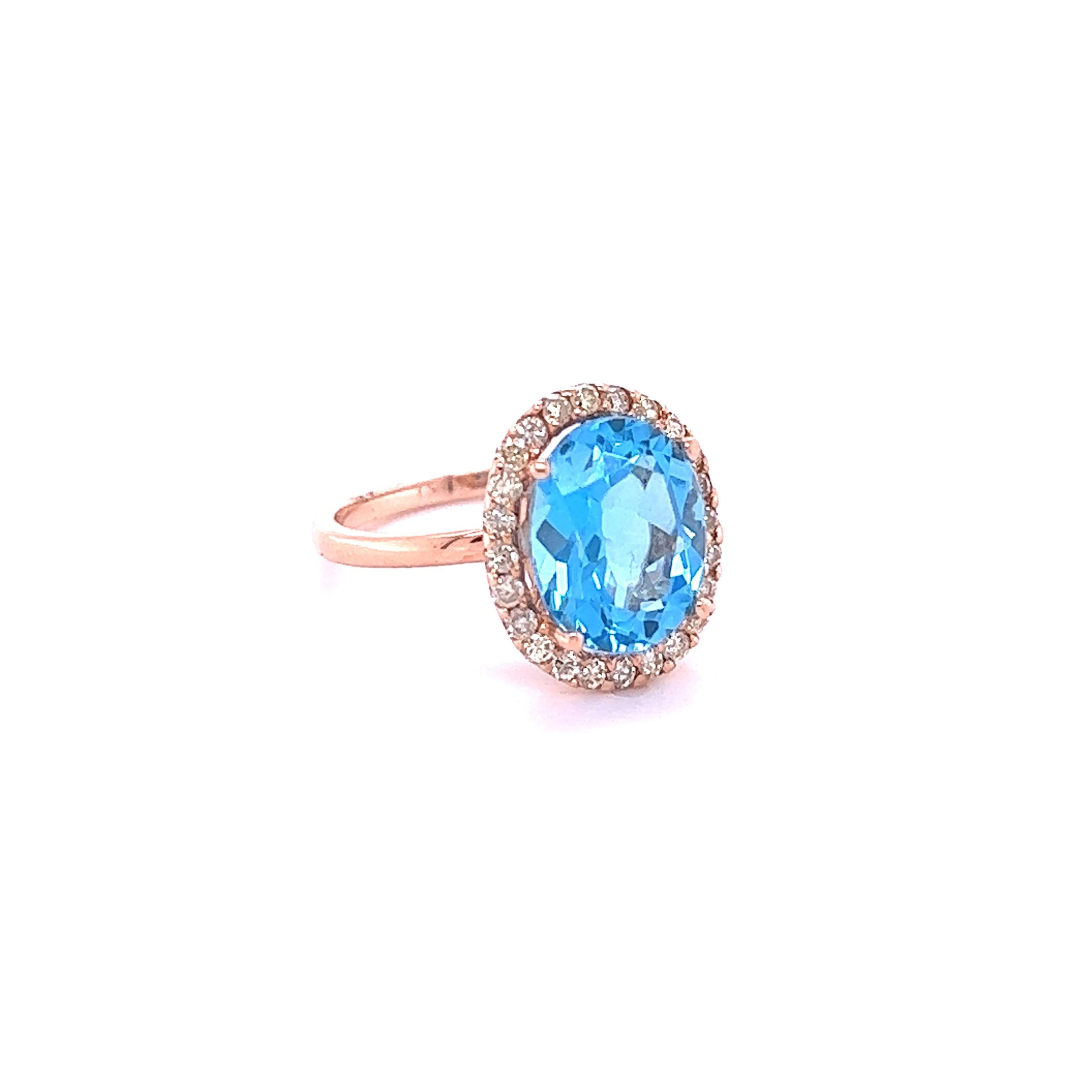 This ring has a Oval Cut Blue Topaz that weighs 4.21 carats and measures at 11 mm x 9 mm. 

It is surrounded by a simple halo of 24 Round Cut Diamonds that weigh 0.42 Carats. The total carat weight of the ring is 4.63 carats.

It is crafted in 14