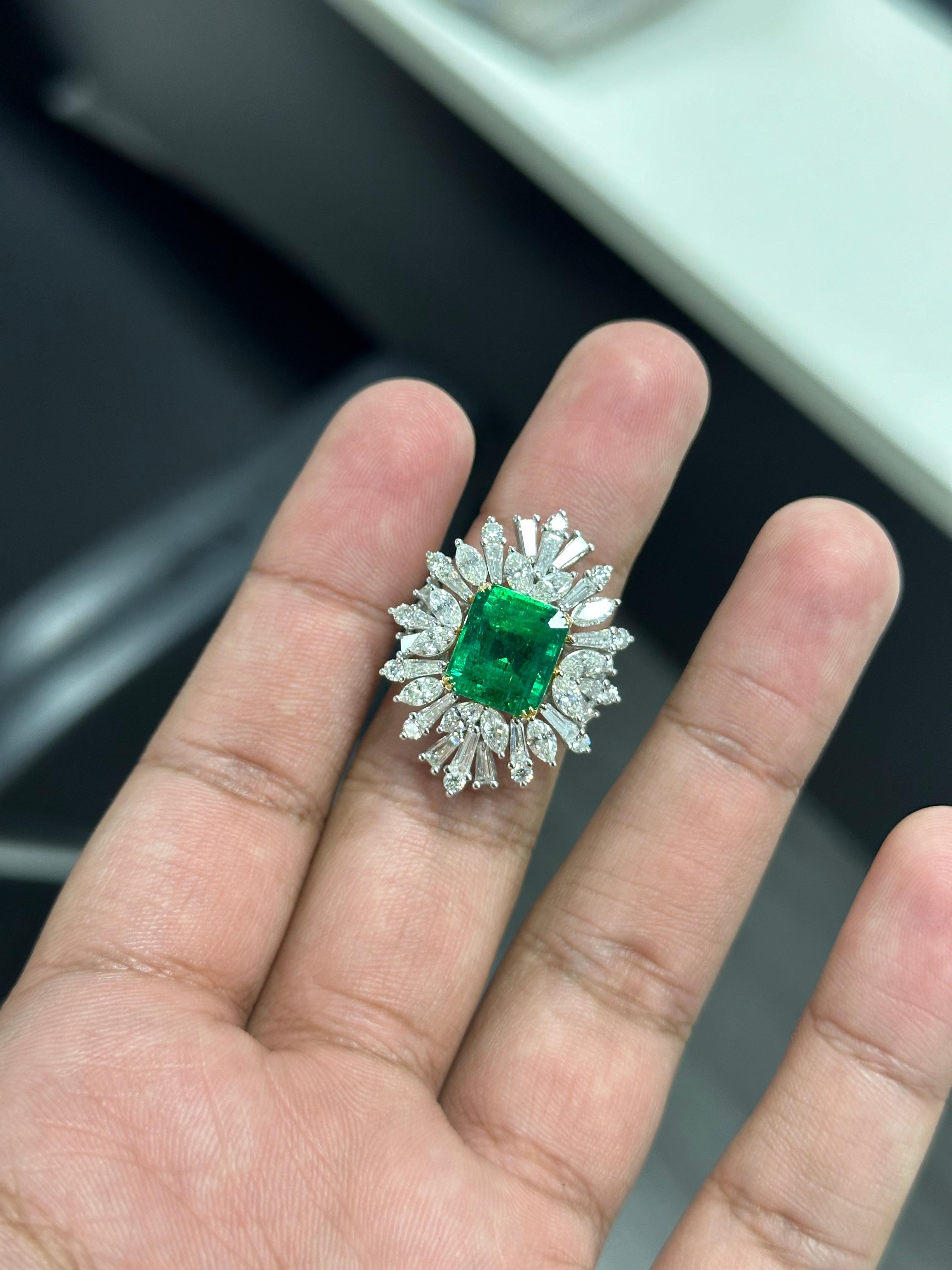 Introducing the epitome of luxury and sophistication, behold the breathtaking Art Deco inspired, Emerald Statement Ring, a true marvel in the world of fine jewelry. Crafted with precision and passion, this extravagant piece exudes opulence from