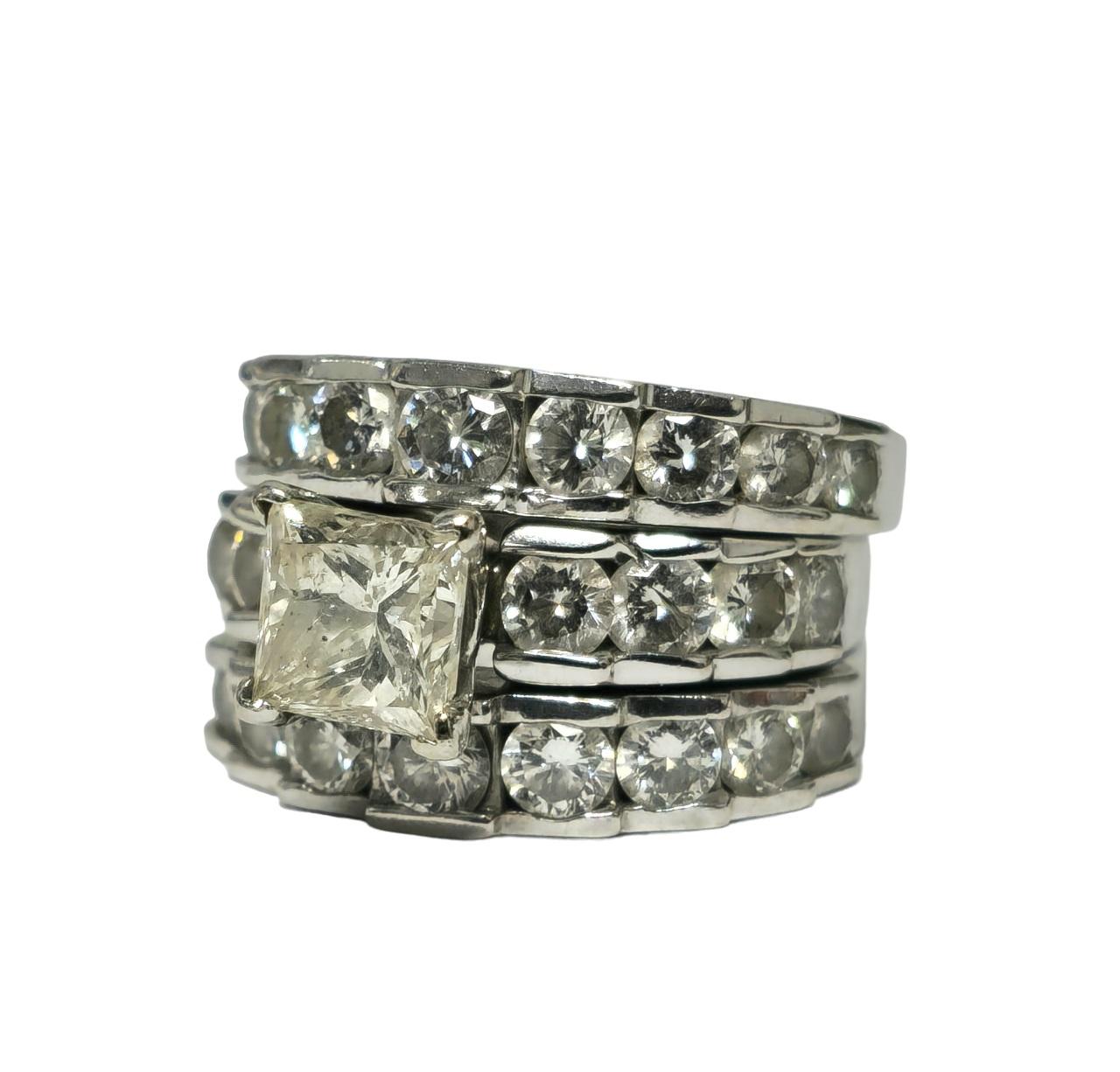 In elegant 14K white gold, this stunning ring features a center princess-cut diamond weighing 1.63 carats with SI2 clarity (enhanced) and I color, complemented by side diamonds totaling 3.00 carats with VS-SI clarity and F-G color in round brilliant