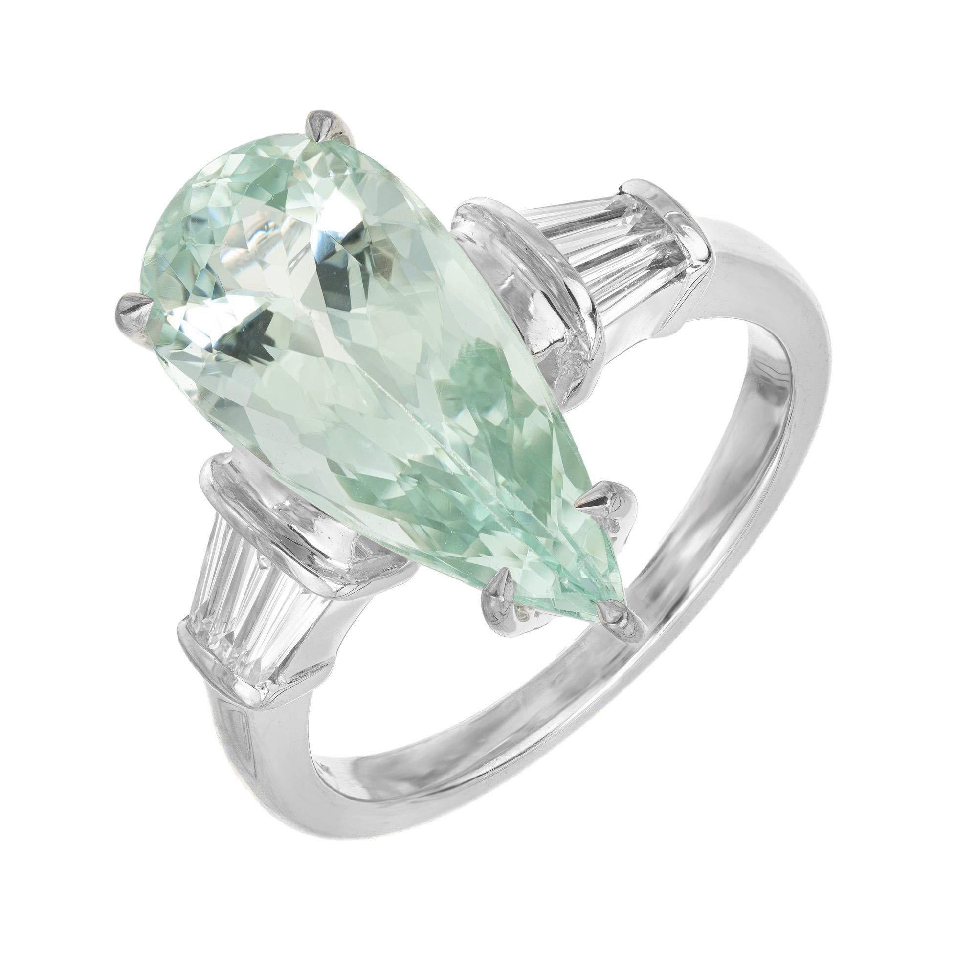 Wonderful 1960's elongated natural aqua and diamond ring. One pear shaped 4.63ct aquamarine mounted in a 14k white gold setting, accented with three baguette diamonds on each side. The aqua has highlighted with beautiful green and blue hues. 

1