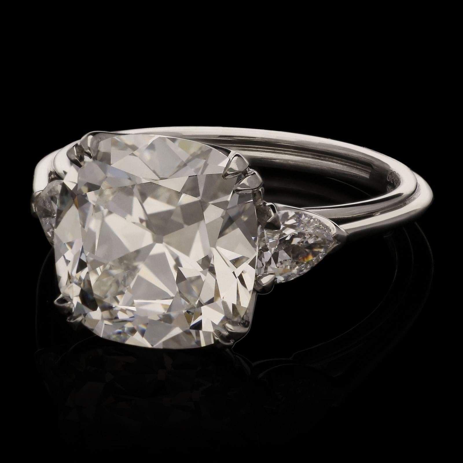 A stunning old cut diamond ring by Hancocks, set to the centre with a beautifully bright and lively old mine brilliant cut diamond weighing 4.63cts and of G colour and VVS2 clarity in double corner claws to a simple scalloped gallery between