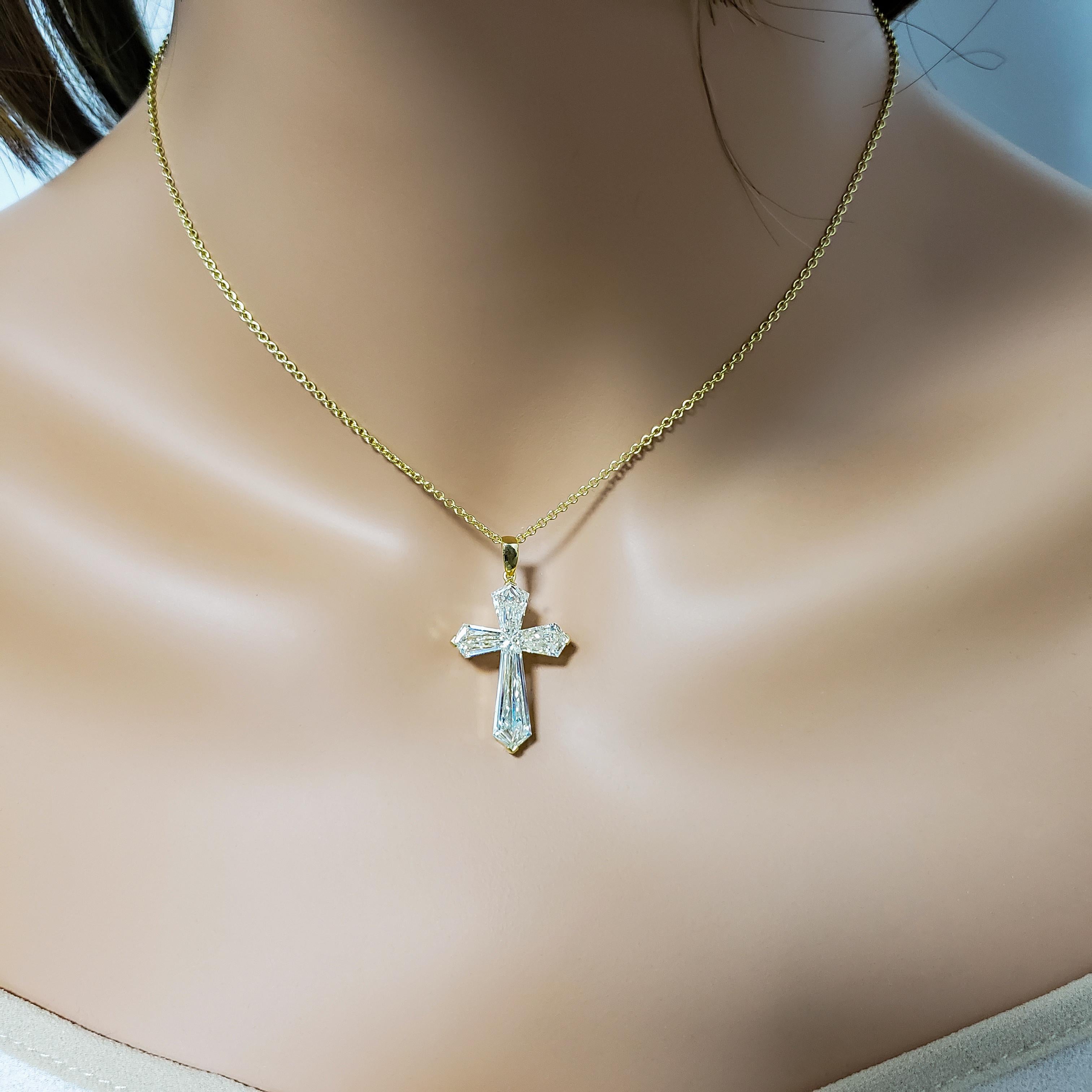 A beautiful cross pendant showcasing four uniquely-cut kite diamonds to shape the pendant in to a cross design. Set in 18k white gold. Diamonds weigh 4.64 carats total and are approximately K color, VS clarity.