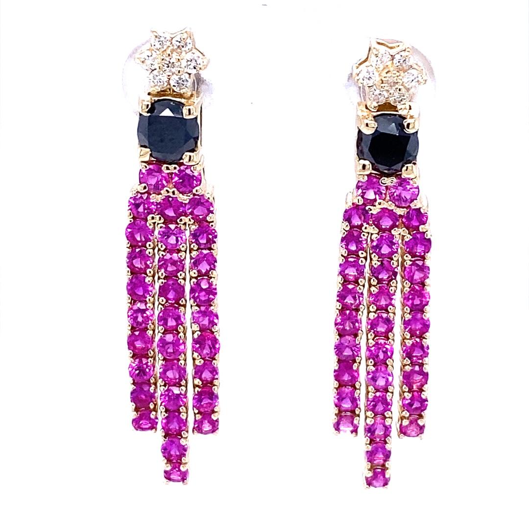 These beautiful earrings have been designed by our in-house designer and has 62 bright Pink Sapphires that weigh 3.39 carats.  The centers are 2 Black Diamonds that weigh 1.05 carats and 14 Round Cut Diamonds that weigh 0.21 carats (Clarity: SI2,