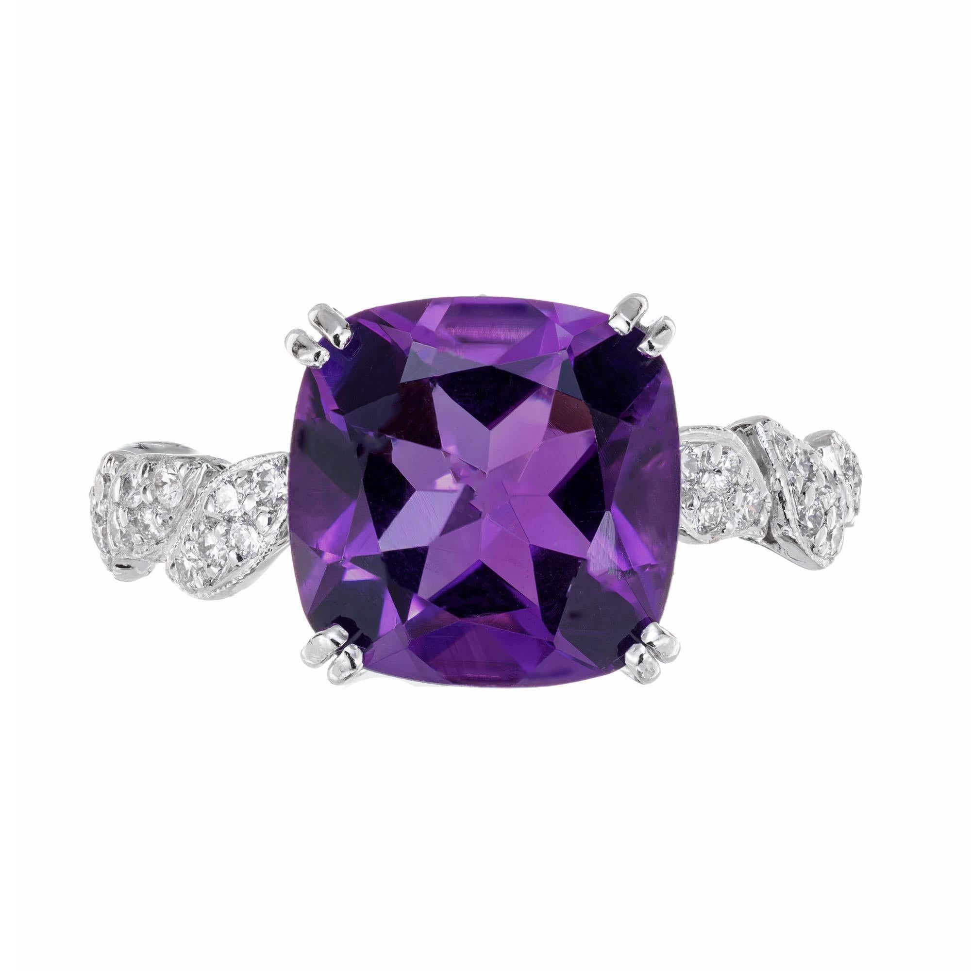 1990's amethyst and diamond ring. 4.66ct cushion cut Amethyst in a platinum setting with 28 round accent diamonds along both sides of the shank. The ring has a serial number. We do not know the maker. 

1 cushion cut deep purple Amethyst, approx.