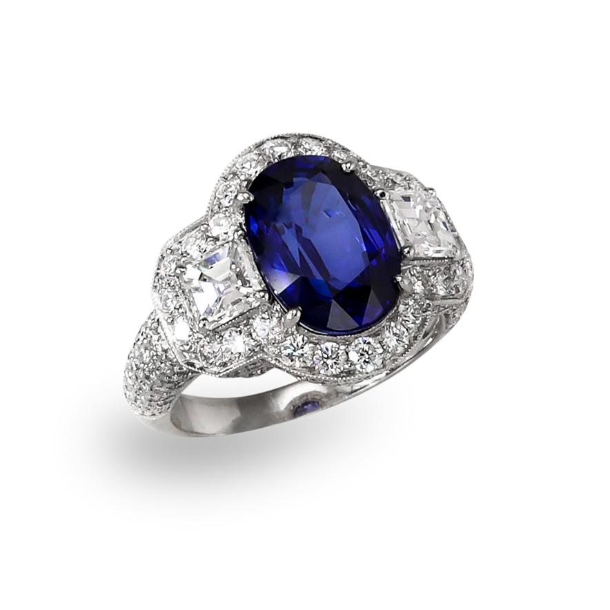 4.66 ct. oval cut Sapphire
.96 ct. square Diamond side stones
1.52 ctw. round brilliant Diamonds
Platinum