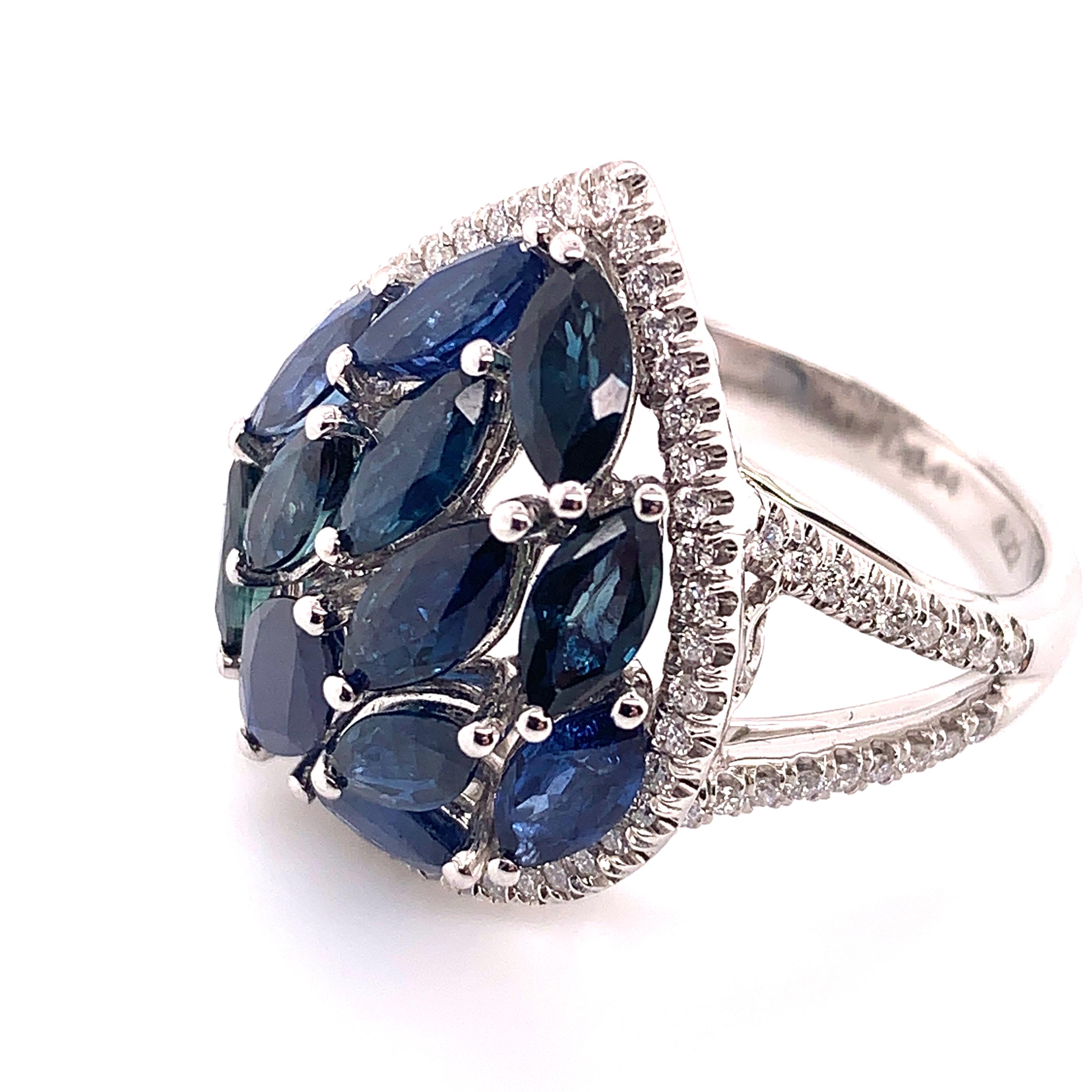 4.66 carat blue sapphire and diamond ring made by Shimon's Creations is set with 18K white gold and and centered by 4.22 carat marquise cut sapphires featuring beautiful strong blue colors and flashes of turquoise. Along the rest of the ring are