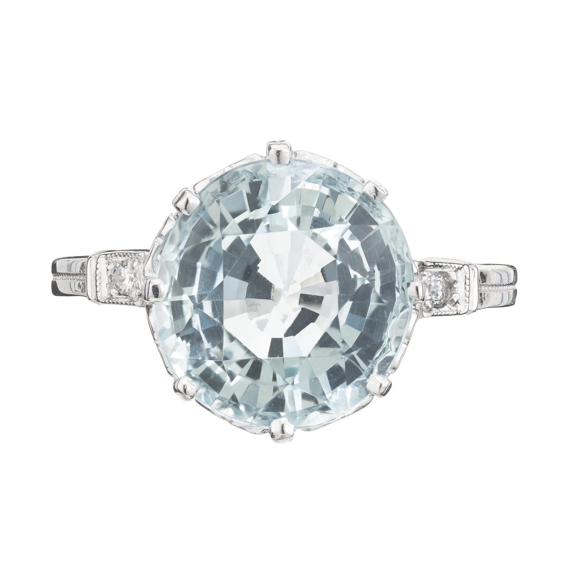 1920's 4.66ct round Aquamarine and Diamond Art Deco platinum engagement ring, a true embodiment of timeless elegance. At the heart of this captivating ring lies a breathtaking 4.66 carat round aquamarine dazzler, with an ocean blue hue. The aqua is