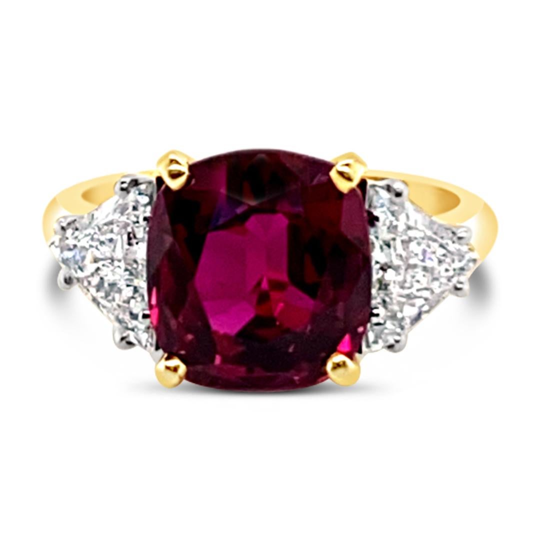 4.66 Carats Oval Ruby Ring set with 1.05 Carats (total weight) Trillion cut diamonds on the side.  Set in 18K Yellow Gold ring.  Diamond trillions are set in Platinum.