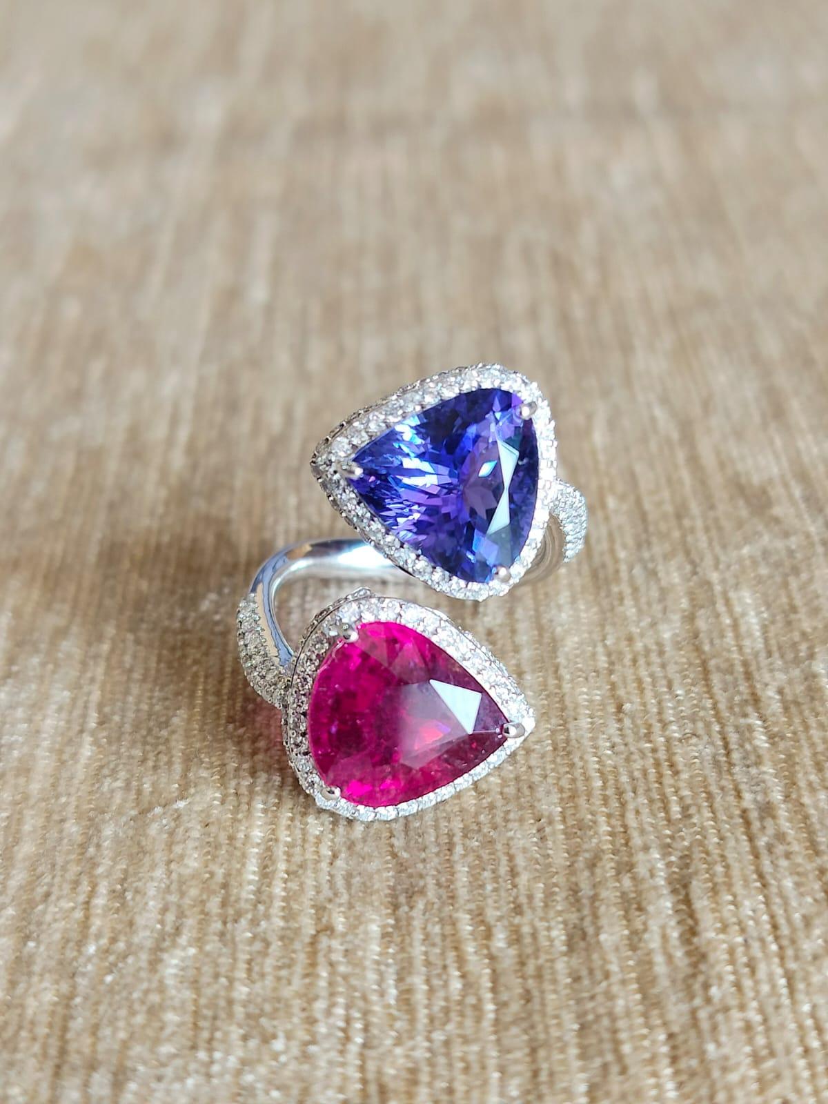 A very gorgeous and modern, Tanzanite and Rubellite Engagement Ring set in 18K Gold & Diamonds. The weight of the Tanzanite is 4.66 carats. The Tanzanite is responsibly sourced from Tanzania. The weight of the Rubellite is 5.03 carats. The Diamonds