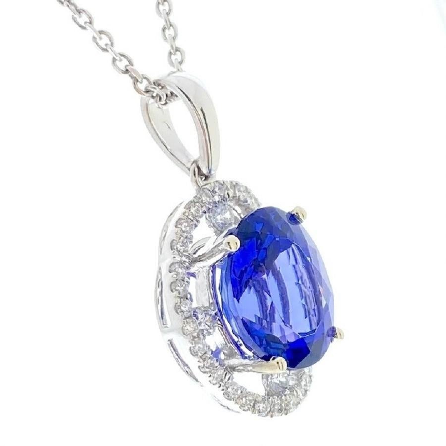 This elegant pendant features a stunning 4.67-carat blue oval tanzanite, known for its deep, captivating shade of blue that shifts beautifully with the light. The tanzanite is gracefully framed by 36 round diamonds, with a total weight of 0.40