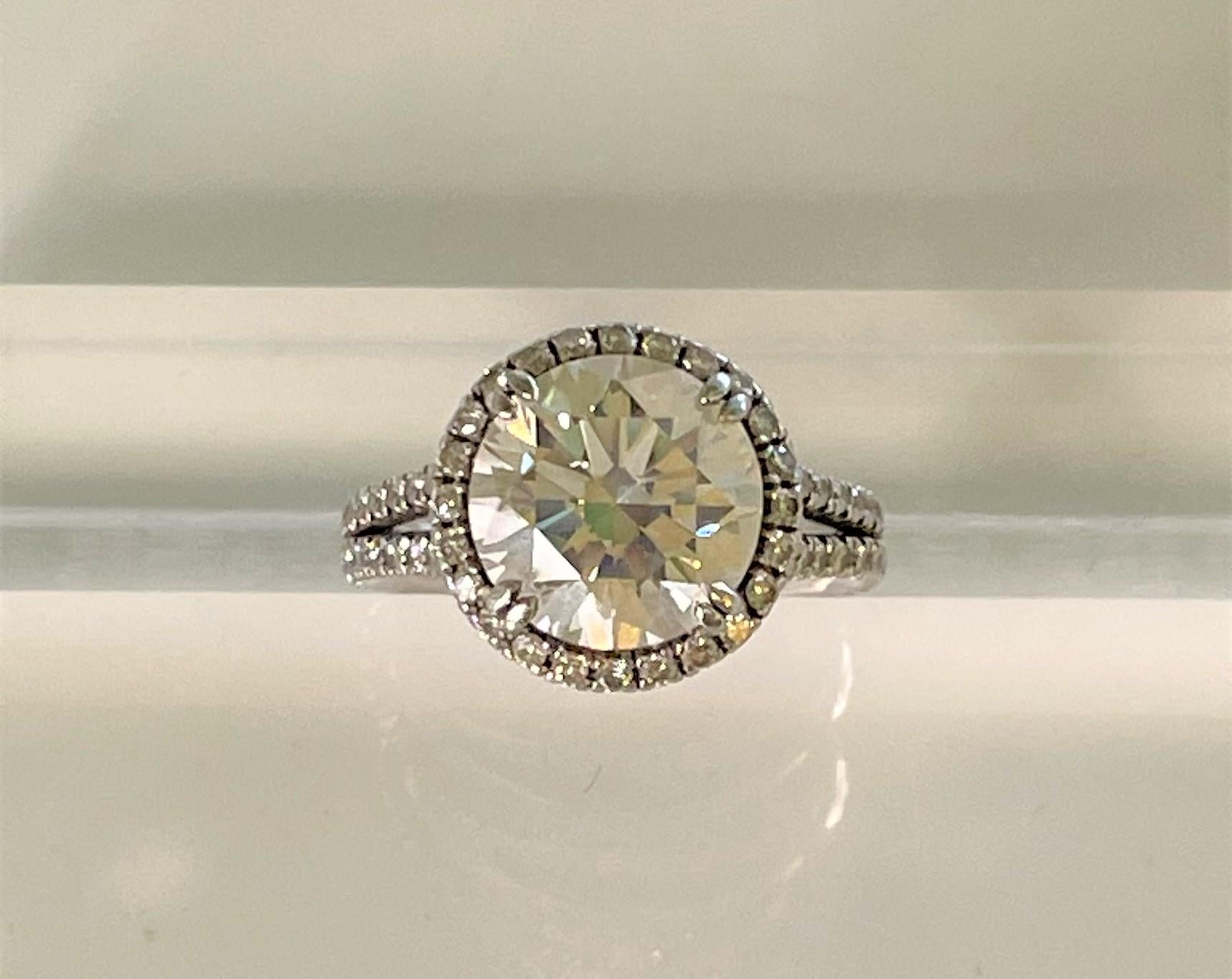 Beautiful, big diamond ring!
4.67ct (estimated weight) round brilliant cut diamond.  Approximately 10.58mm x 10.6mm x 6.82mm.  
     L color, I2 clarity
48 round brilliant cut diamonds.  Approximately .01ct each.  H-I color, SI1-SI2 clarity 
14K