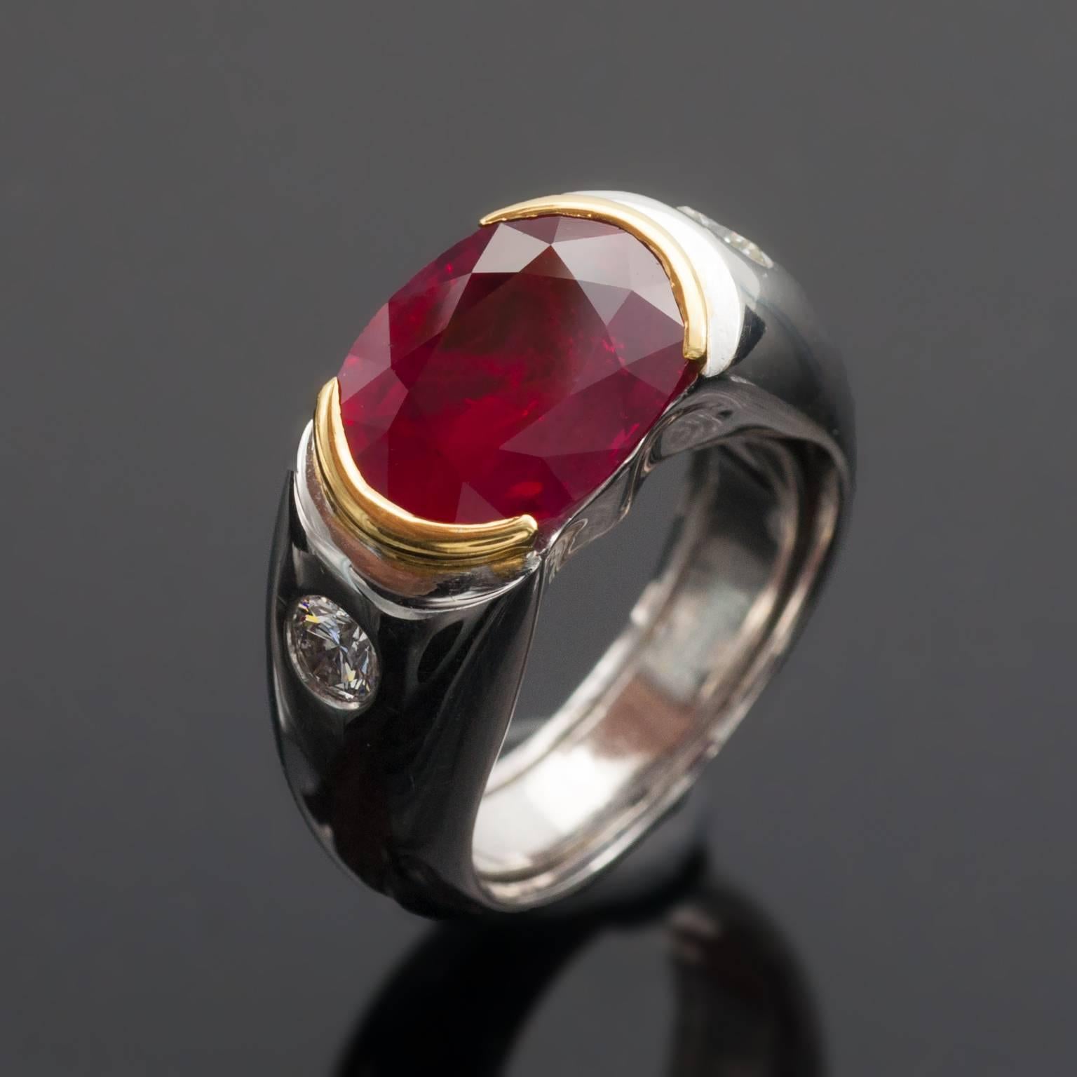 This unique modern solitaire is composed by a 4.10 carat ruby and two shoulder stones weighing each 0.15ct. 
The ruby measuring 11.8x9mm (0.46x0.35 in) show more than its actual weight. 
A spring hidden in the shank makes the ring more confortable