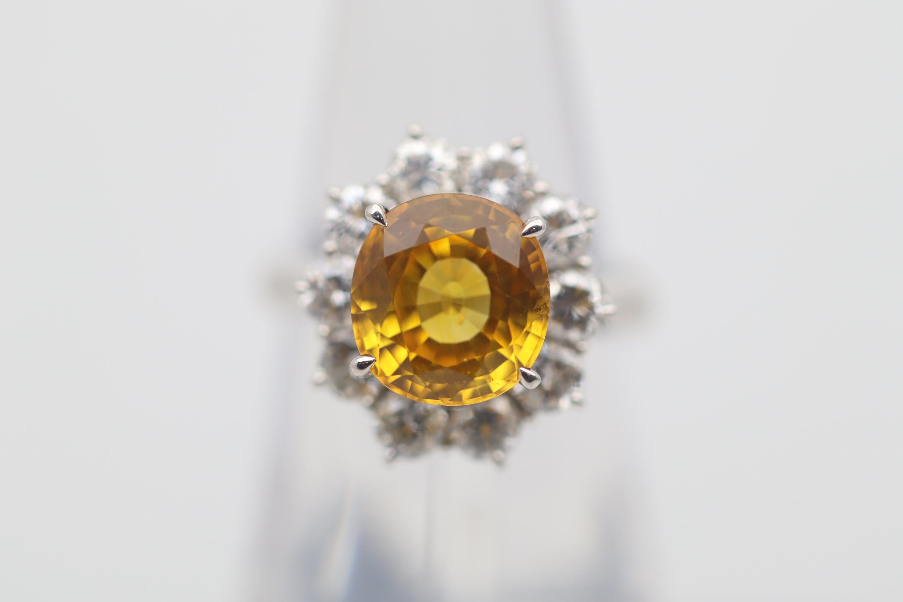 Here we have a lovely platinum ring with a fine orange sapphire weighing an impressive 4.68 carats. It has a bright, vivid yellowish-orange color that is full of brilliance and sparkle which makes the color even more impressive. It is complemented