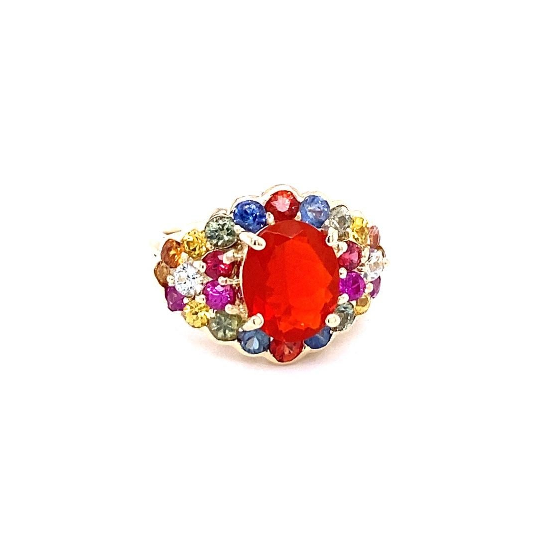 4.68 Carat Oval Cut Fire Opal Sapphire 14 Karat Yellow Gold Cocktail Ring

This ring has a 1.99 Carat Oval Cut Fire Opal as its center stone and is elegantly surrounded by 24 Round Cut Multi-Colored Sapphires that weigh 2.69 Carats. The measurements