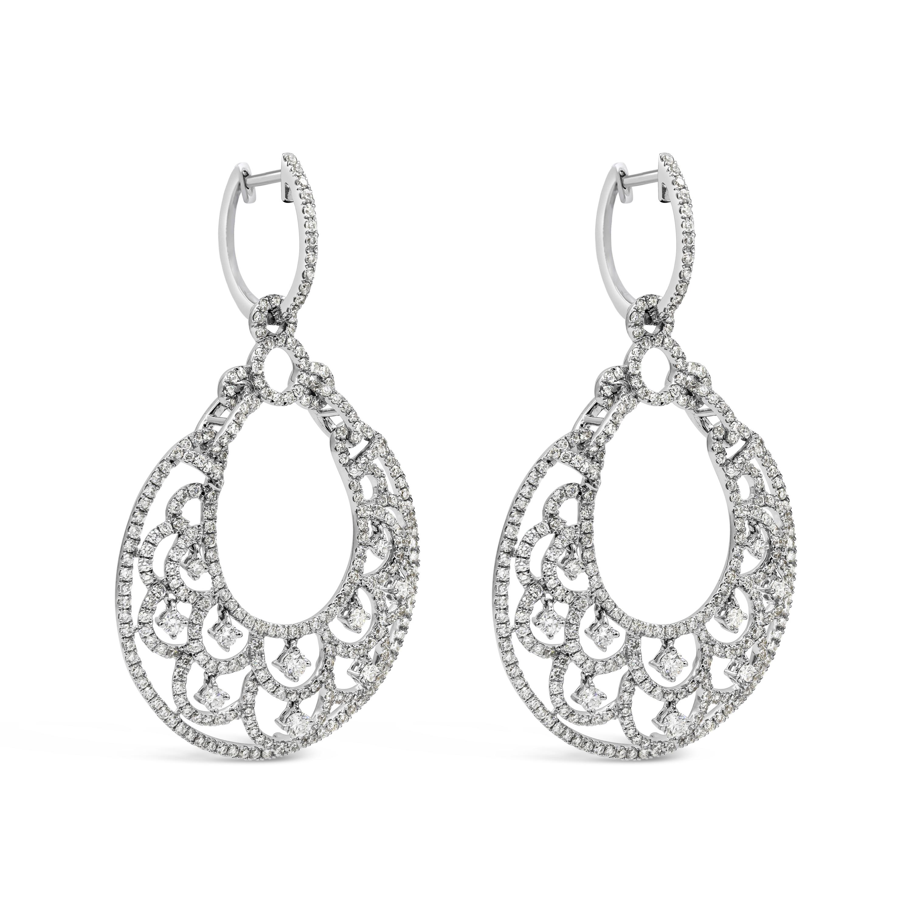 An appealing pair of earrings showcasing a croissant shape open work design dangling earrings. Diamonds weigh 4.68 carats total, Accented by single cut diamonds each set and free dangling. Suspended on a diamond encrusted lever back. Made in 18k
