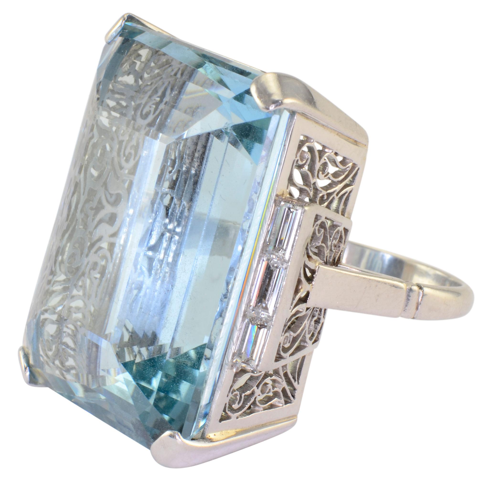 Vintage 46.88 carat aquamarine and diamond platinum ring, circa 1960. This vintage ring has an emerald cut aquamarine at 46.88 carats and six baguette diamonds at 0.50 carat total weight VS1 clarity F-G clarity set in a pierced gallery. The vintage