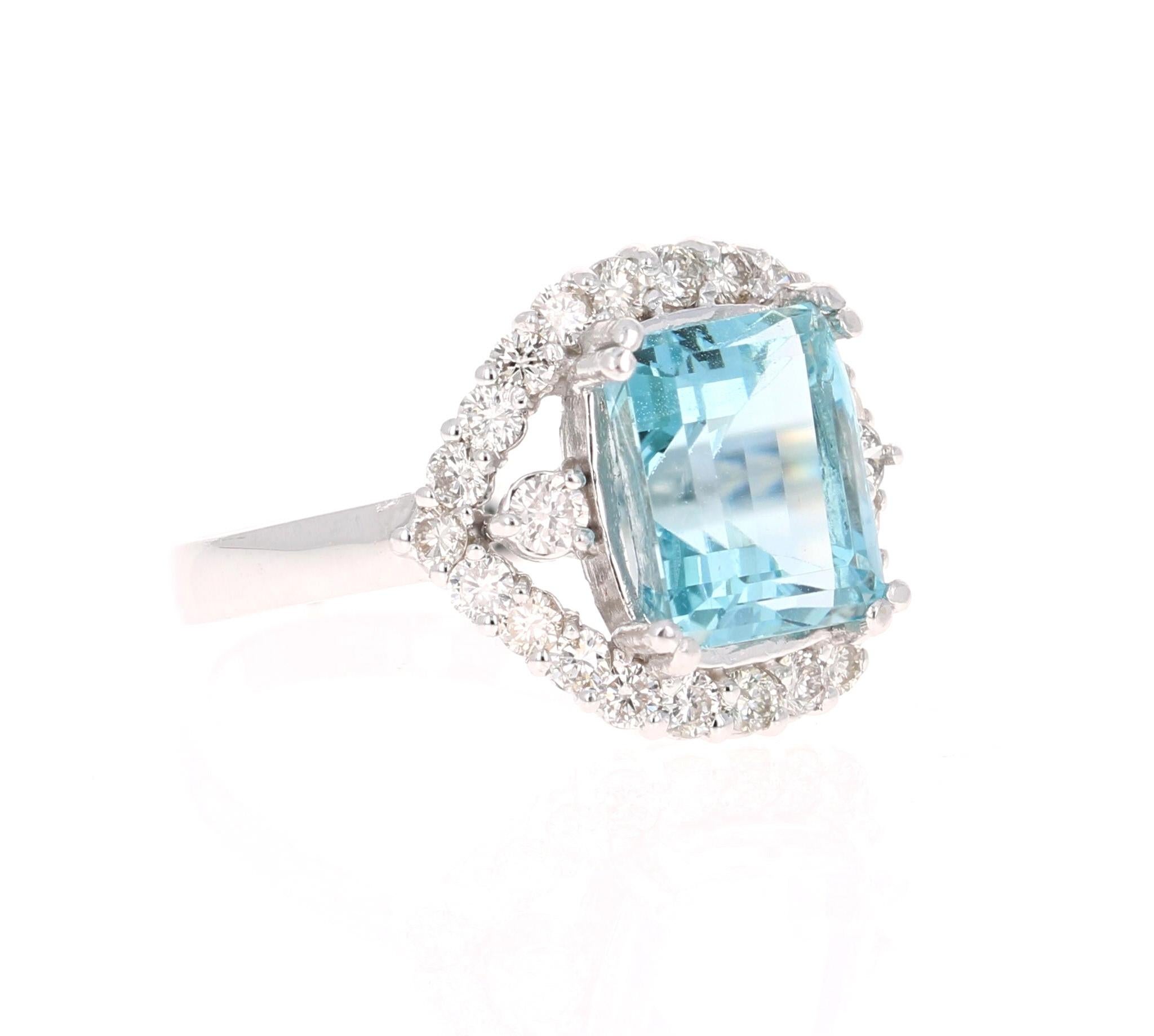 
This ring has a beautiful 3.87 Carat Emerald Cut Aquamarine set in the center of the ring and is surrounded by 24 Round Cut Diamonds that weigh 0.82 Carats (Clarity: VS2, Color: H). The total carat weight of this ring is 4.69 Carats. 
The