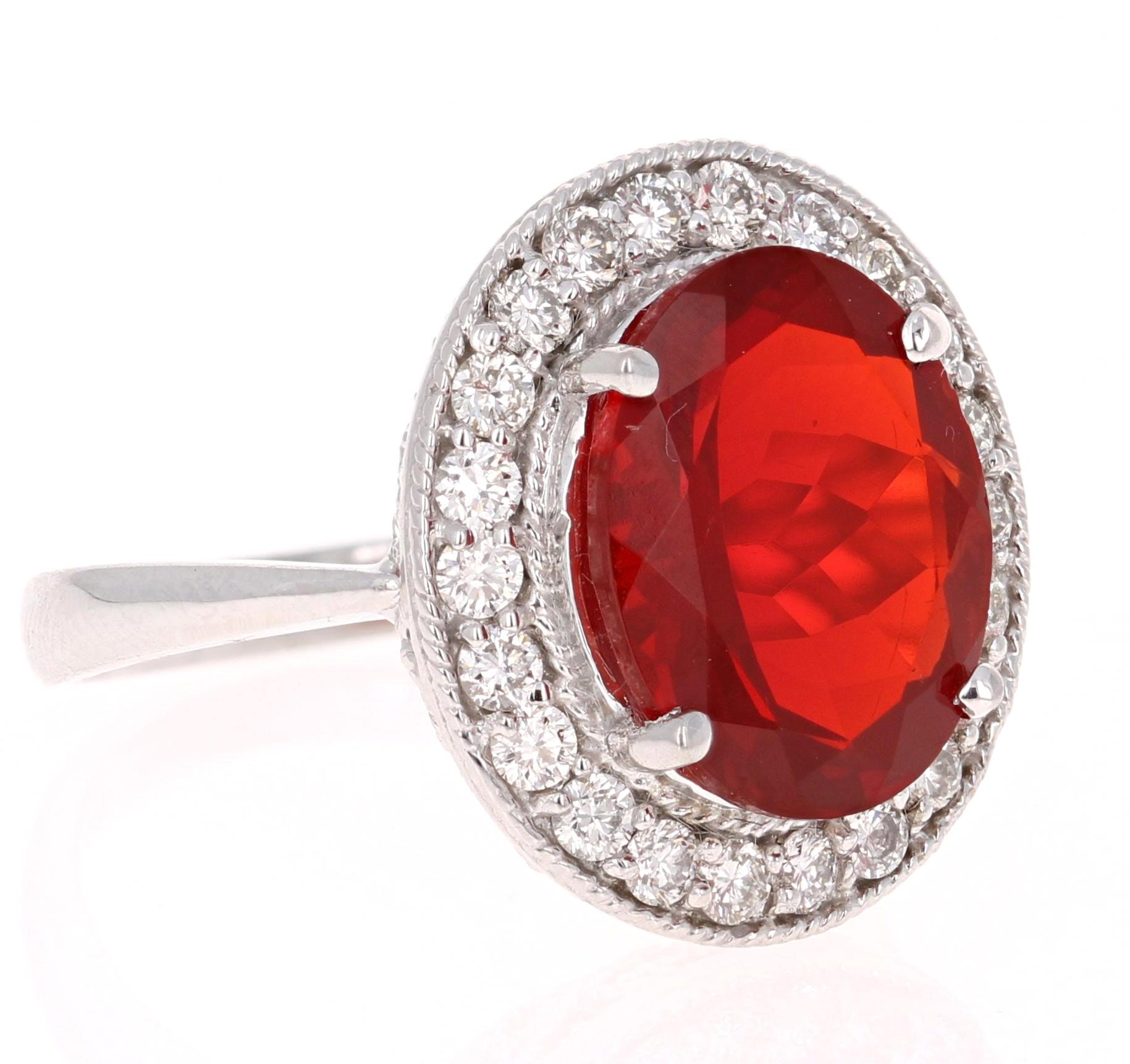 The Fire Opal is 3.99 Carats and is surrounded by 22 Round Cut Diamonds that weigh 0.70 Carats. 

It is set in 14K White Gold and is approximately 5.4 grams. 

The ring size is 7 and can be re-sized at no additional charge. 