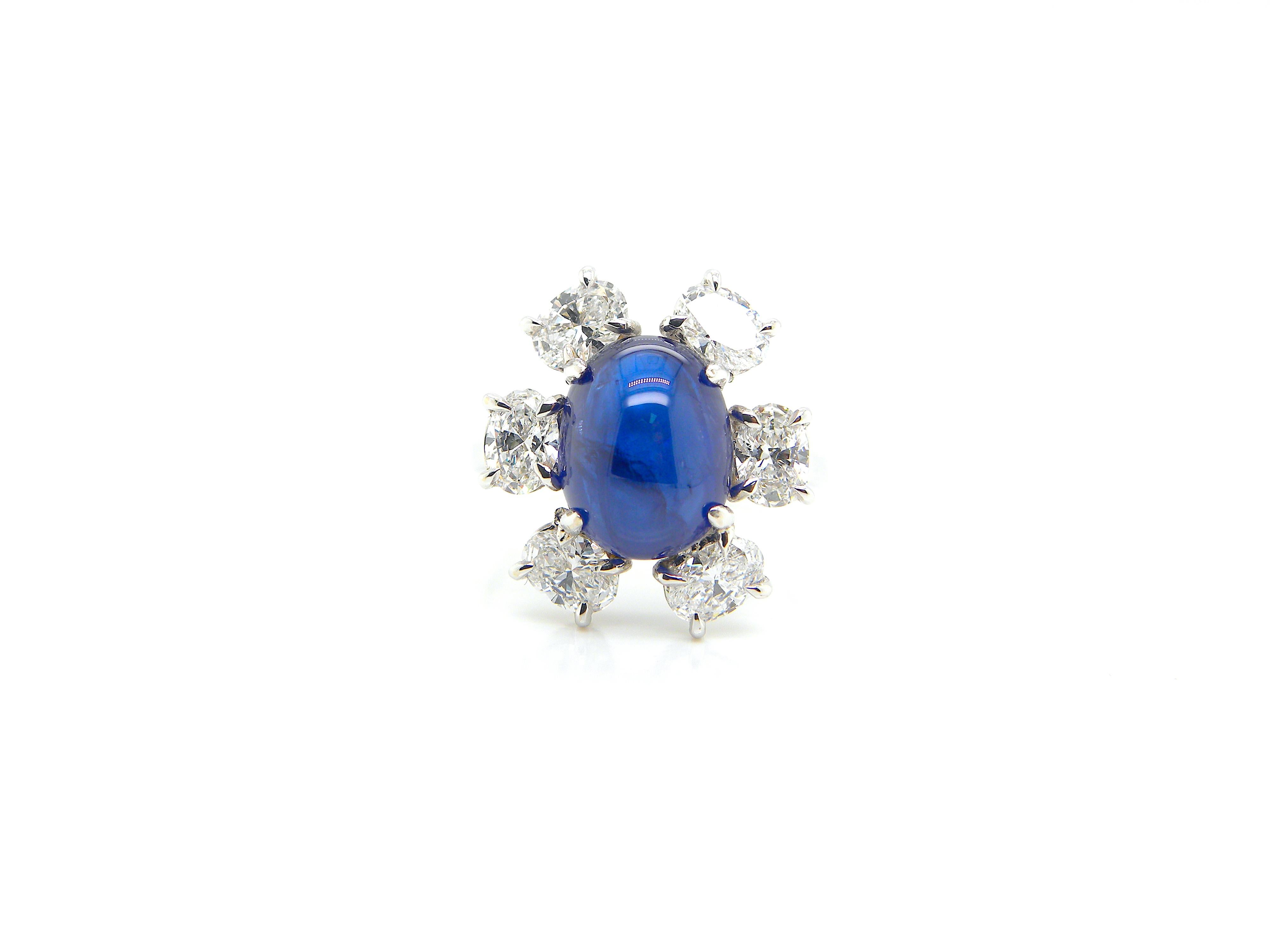 4.69 Carat GRS Certified Burma No Heat Blue Sapphire Cabochon and Diamond Ring:

A rare jewel, it features a 4.69 carat GRS certified Burmese unheated sapphire cabochon surrounded by a flurry of super-white oval diamonds weighing 1.50 carat. The